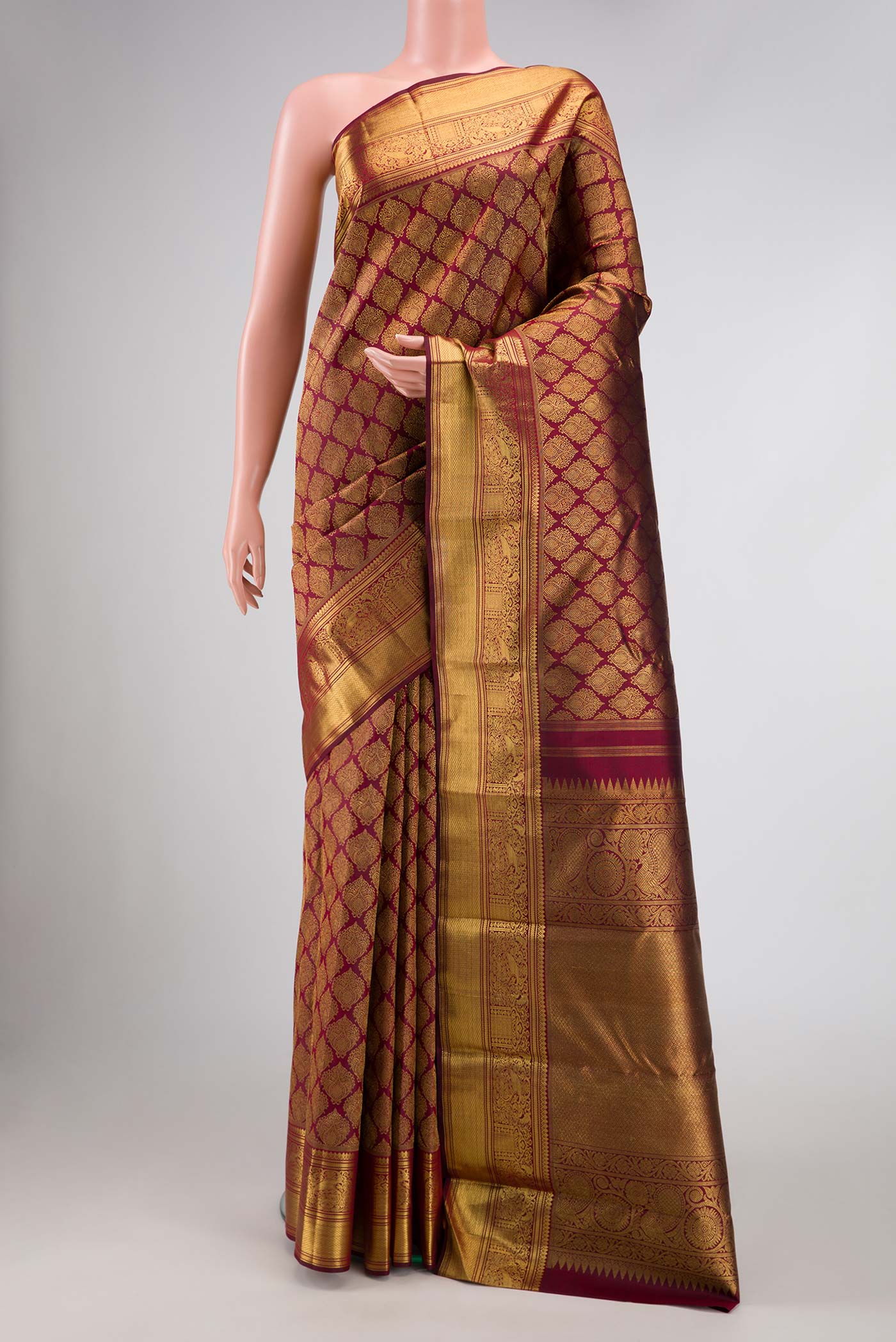 Pure Silk Pure Zari Maroon Dual Tone Kanchipuram Saree with Zari Brocade on the body and Zari Border displayed on a mannequin