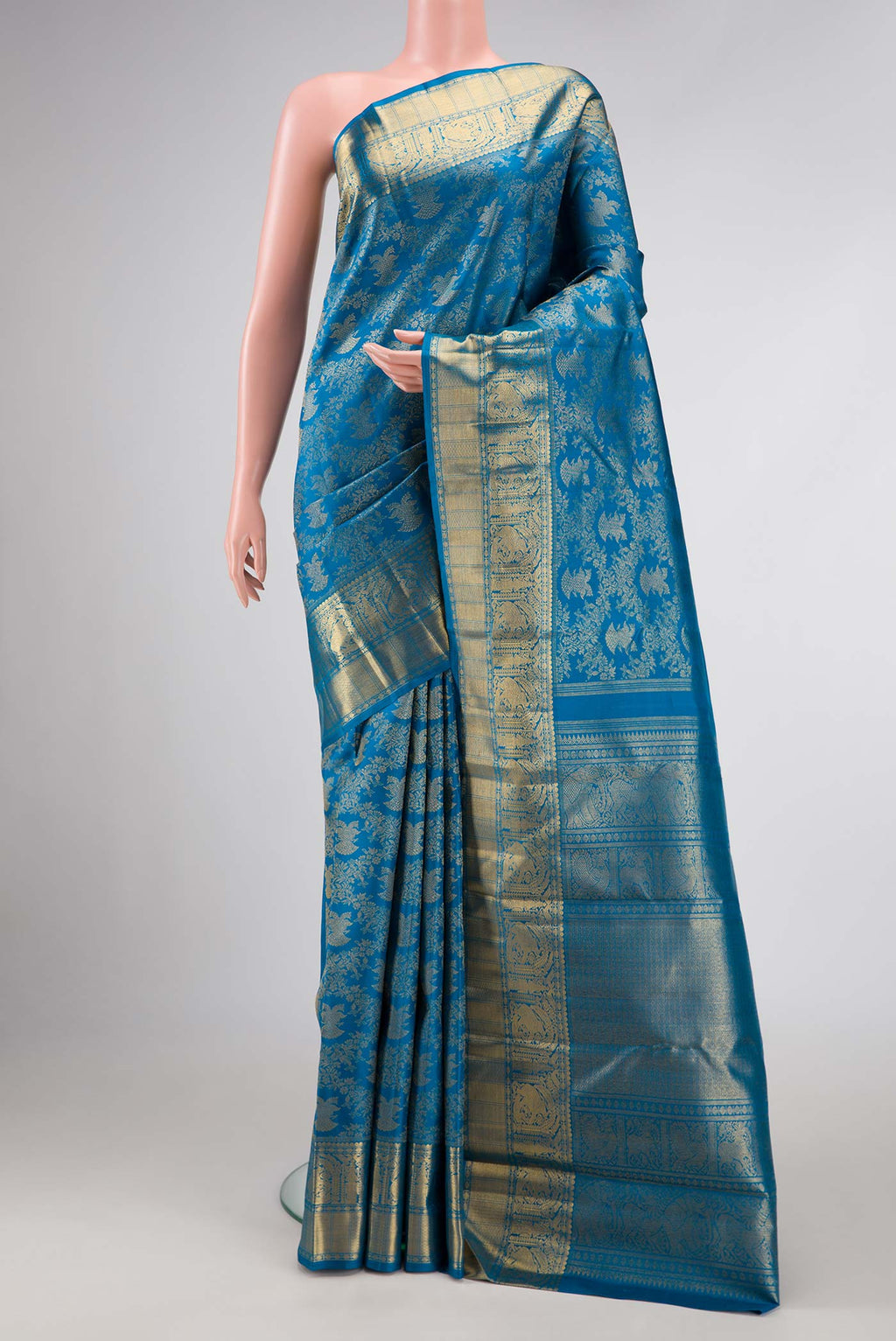 Pure Silk Pure Zari Peacock Blue Dual Tone Kanchipuram Saree with Zari Brocade on the body and Zari Border displayed on a mannequin