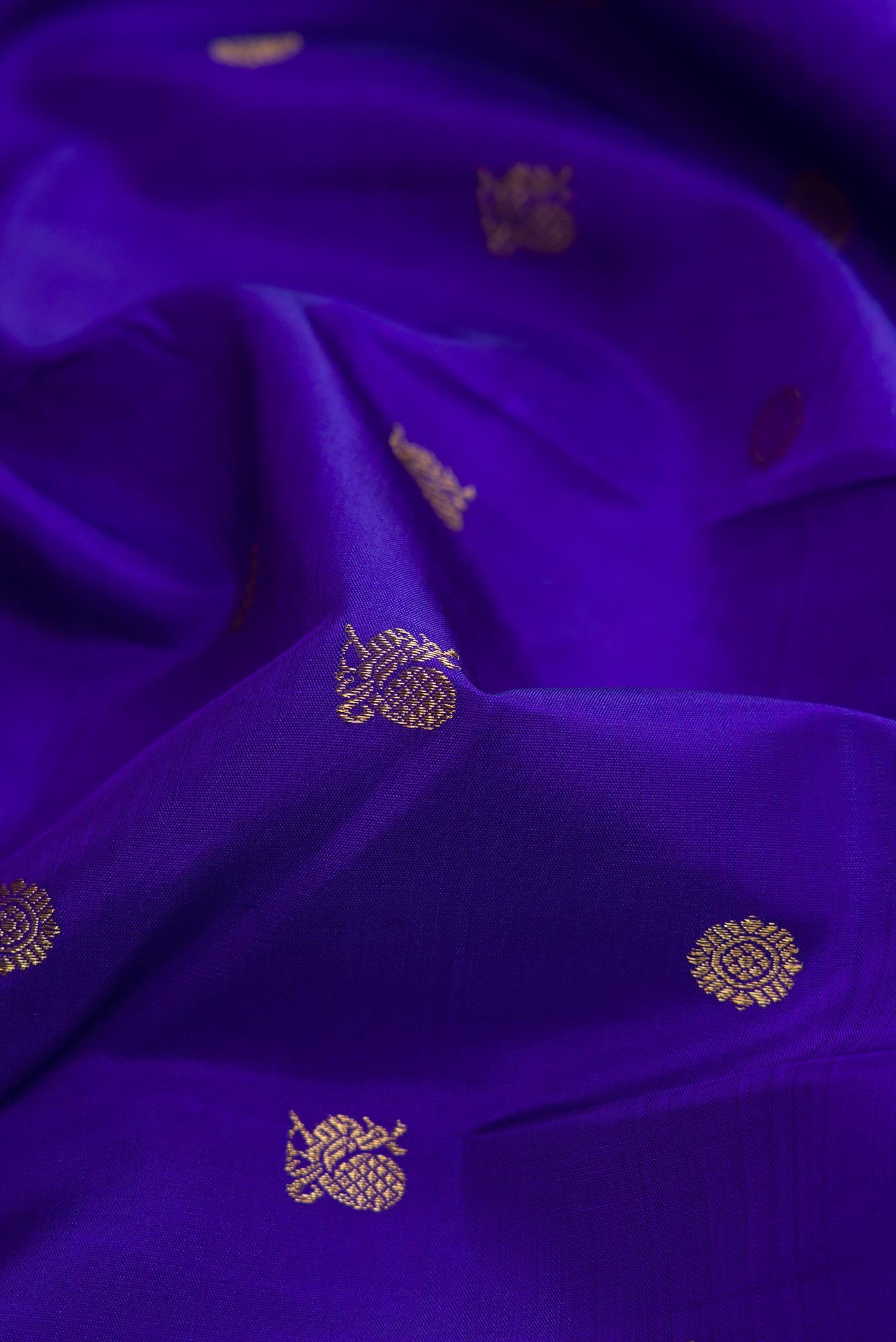 Close up of Pure Silk Pure Zari Royal Blue Dual Tone Kanjivaram Saree with Zari Butta on the body and Zari Border.  displaying folds