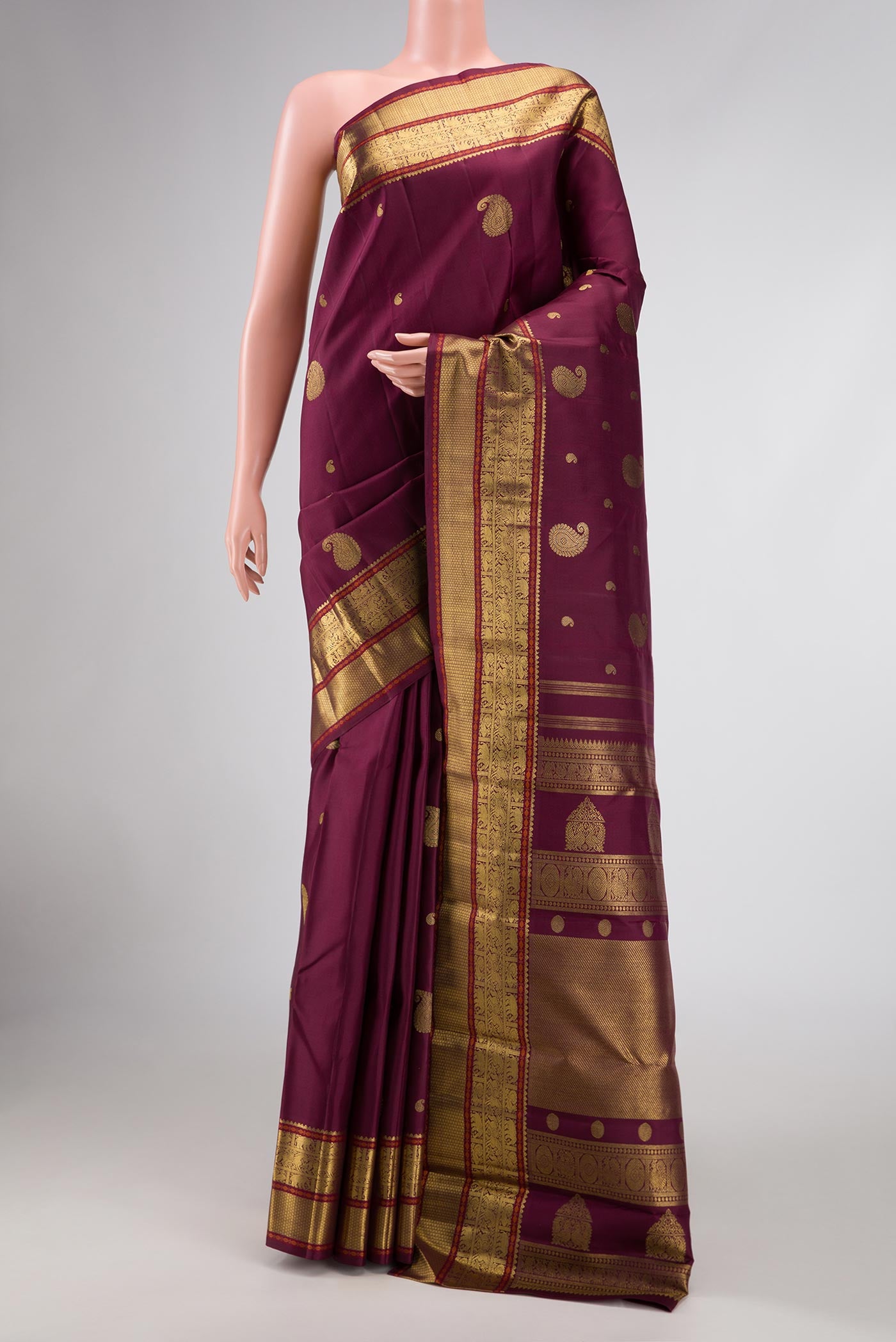 Pure Silk Pure Zari Maroon Dual Tone Kanjivaram Saree with Zari Butta on the body and Zari Border.  displayed on a mannequin