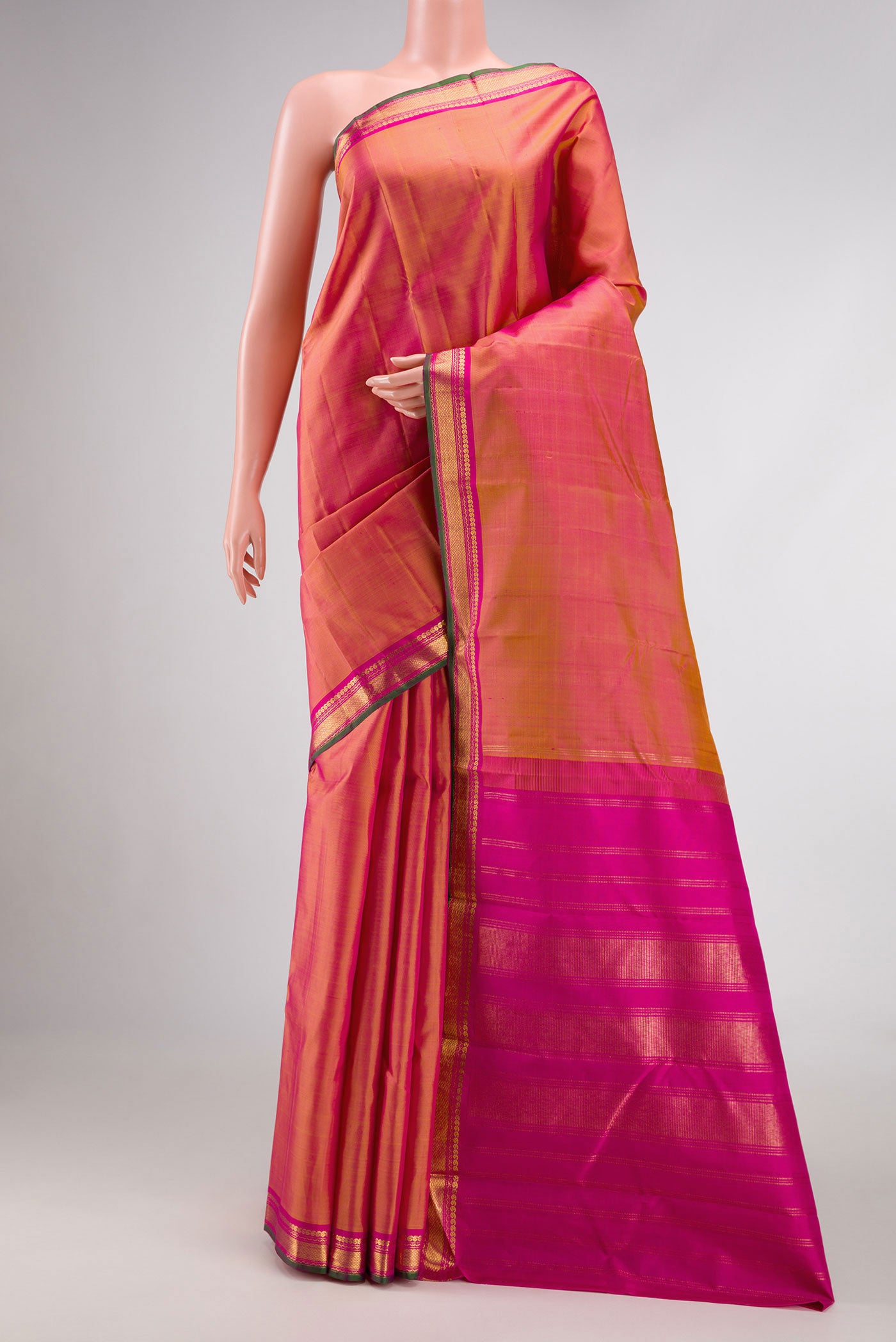 Coral Dual Tone Kanjivaram Silk Saree with Plain Body and Zari Border.  displayed on a mannequin