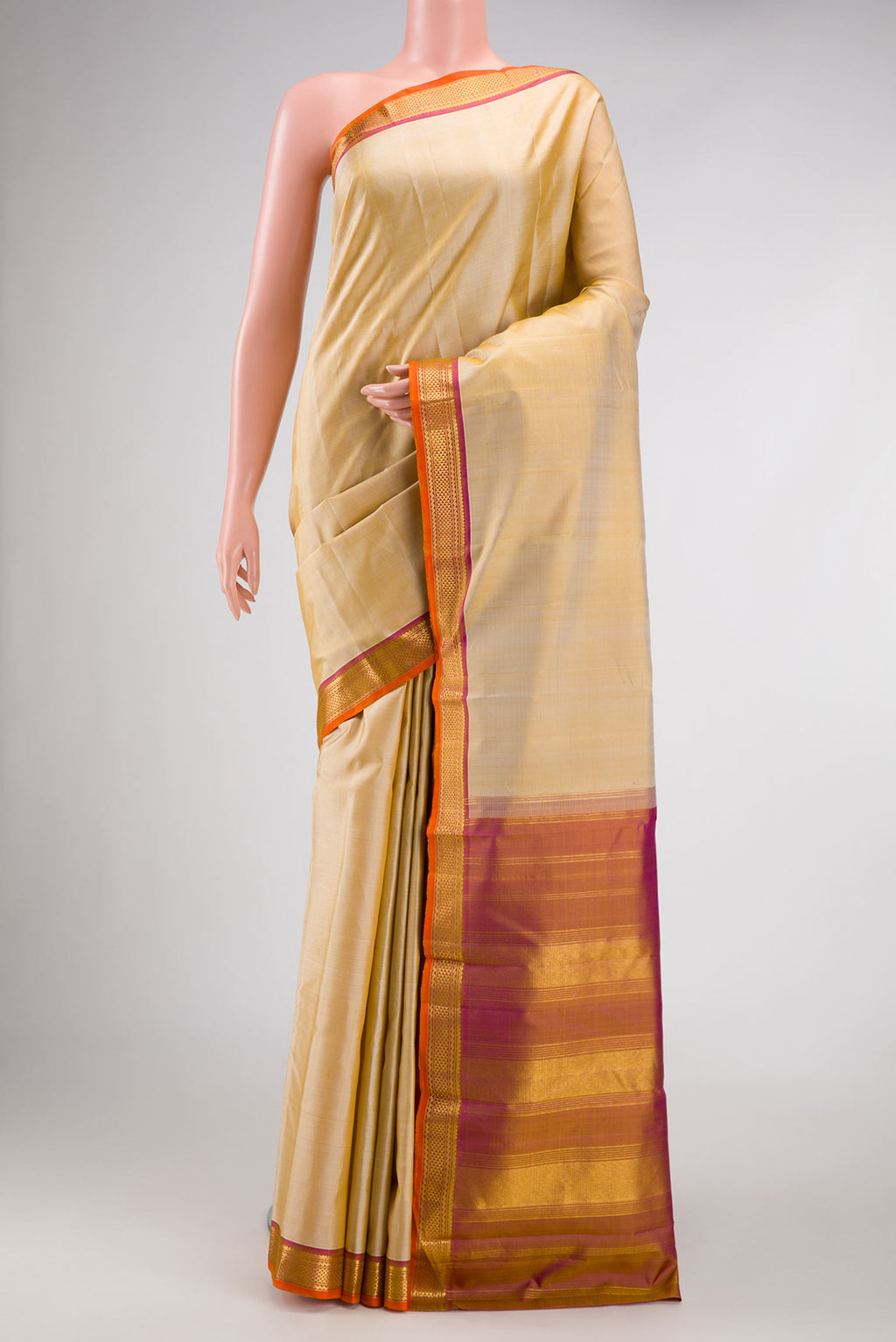 Beige Dual Tone Kanjivaram Silk Saree with Plain Body and Thread Border.  displayed on a mannequin