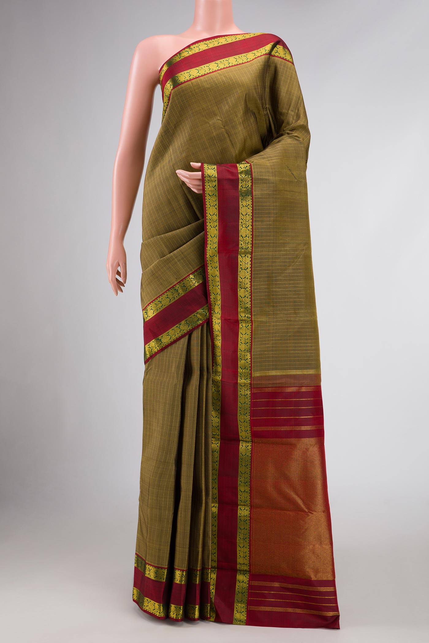 Mehandi Green Dual Tone Kanchipuram Silk Saree with Stripes on the body and Zari Border.  displayed on a mannequin