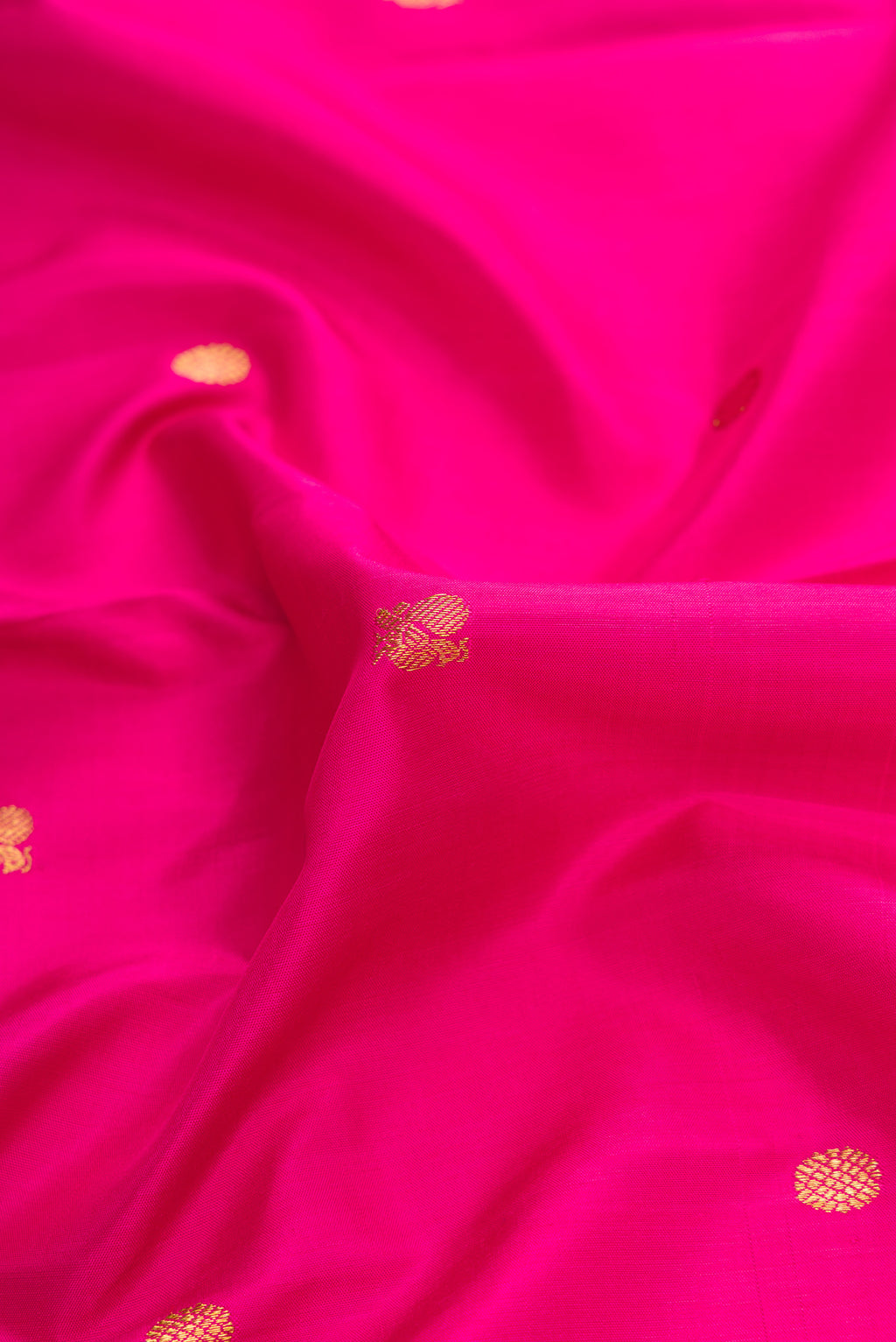 Close up of Pink Dual Tone Kanchipuram Silk Saree with Zari Butta on the body and Zari Border.  displaying folds