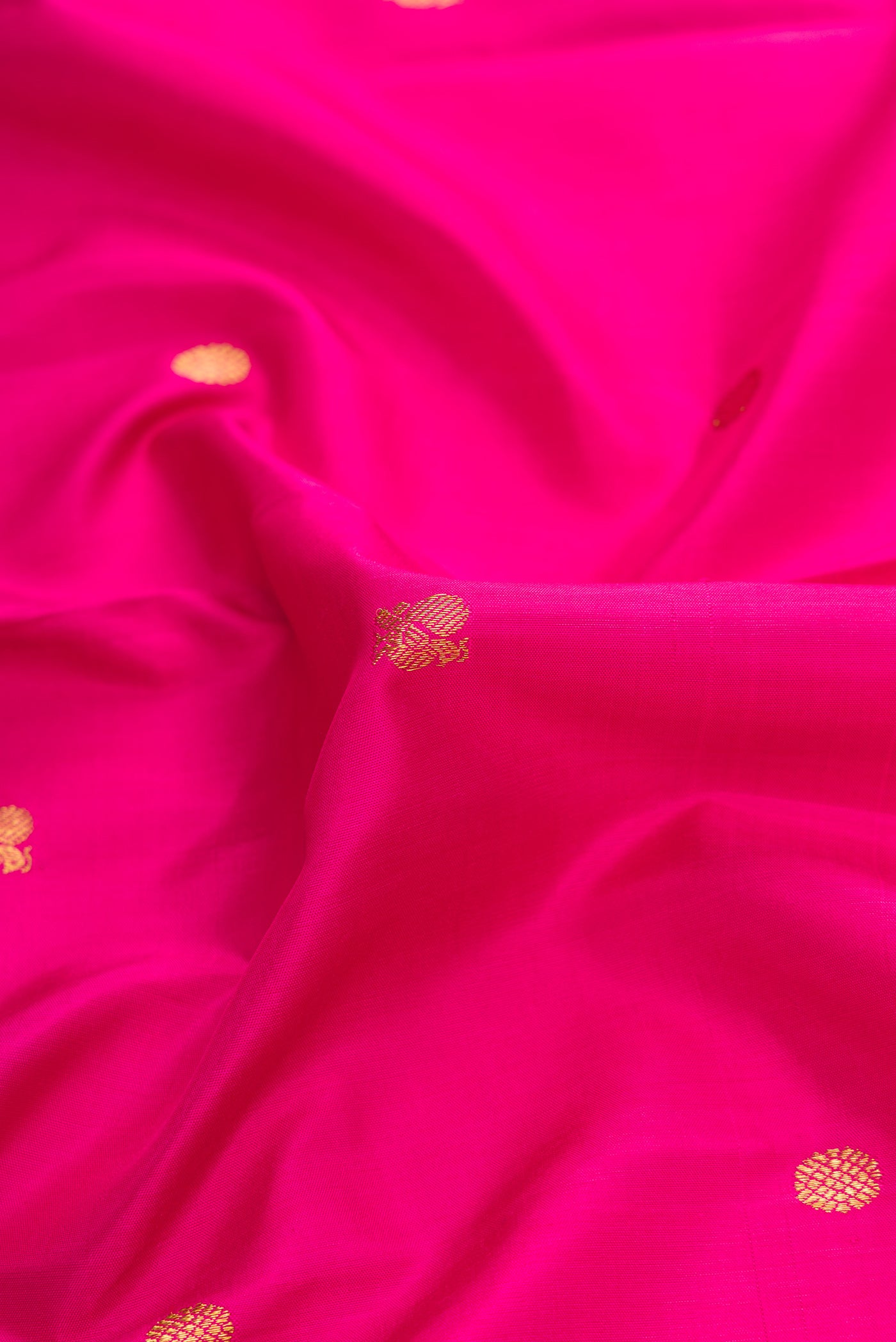 Close up of Pink Dual Tone Kanchipuram Silk Saree with Zari Butta on the body and Zari Border.  displaying folds