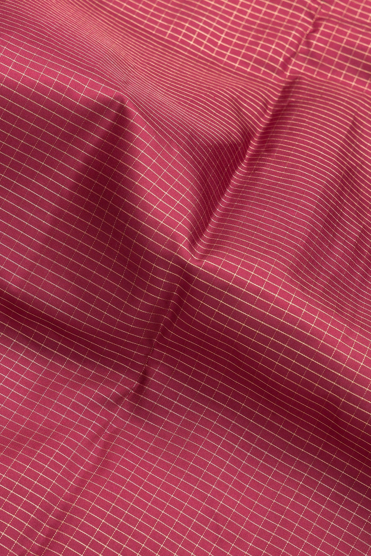 Close up of Maroon Dual Tone Kanchipuram Silk Saree with Checked design on the body and Zari Border.  displaying folds