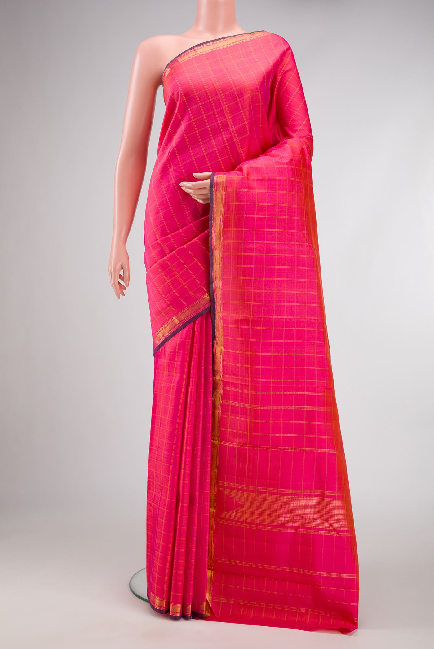Orange Dual Tone Kanchipuram Silk Saree with Checked design on the body and Zari Border.  displayed on a mannequin