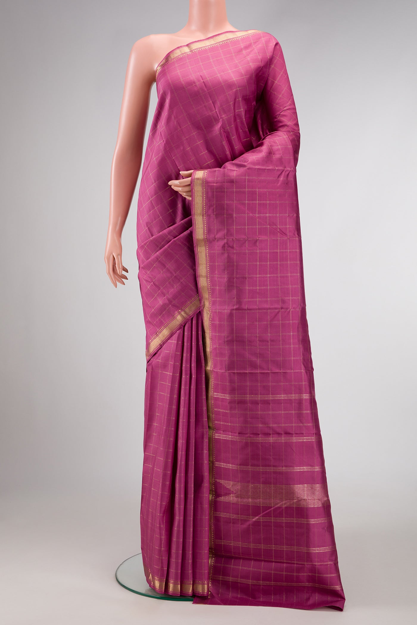 Pink Dual Tone Kanchipuram Silk Saree with Checked design on the body and Zari Border.  displayed on a mannequin