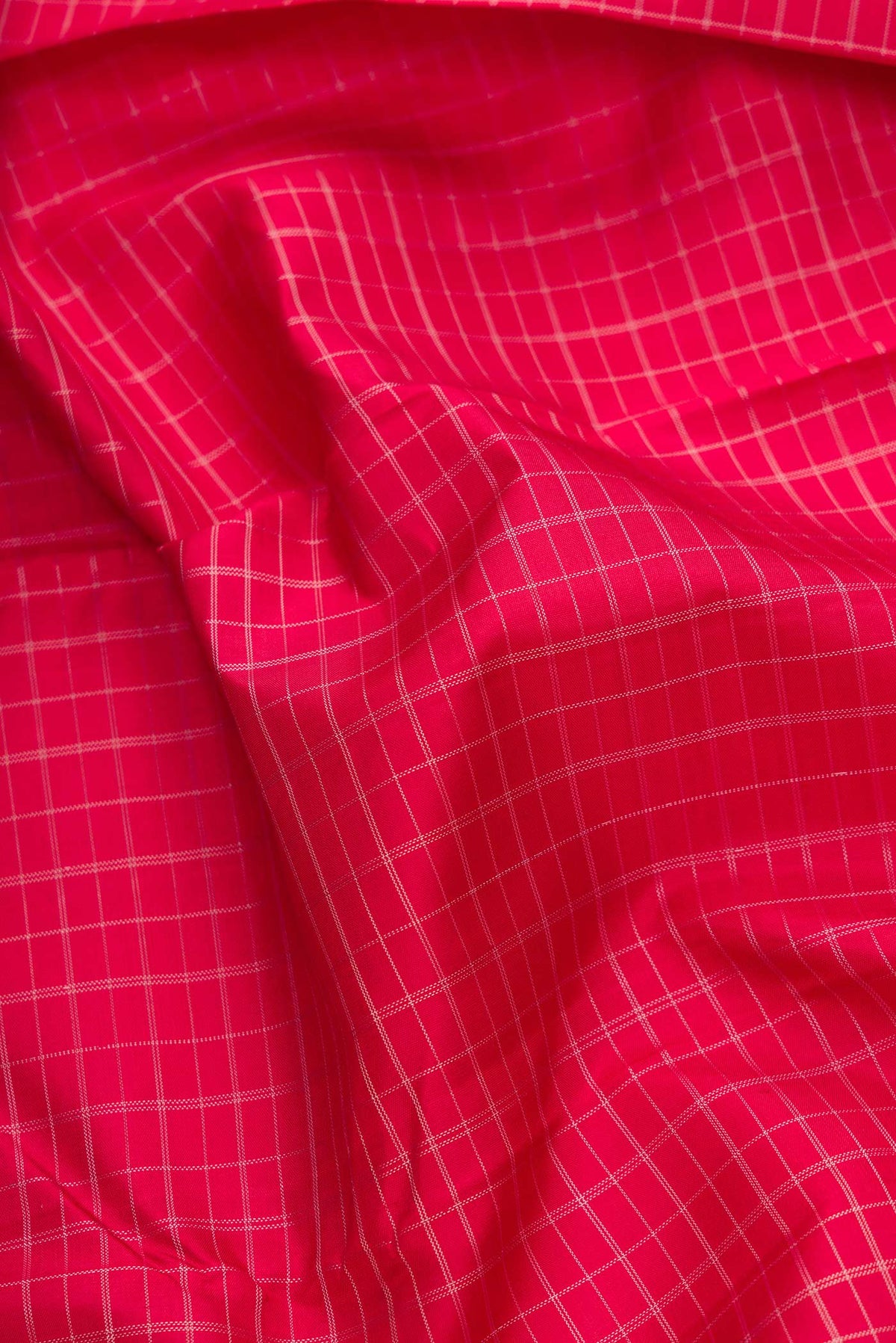 Close up of Pure Silk Pure Zari Maroon Dual Tone Kanjivaram Saree with Checked design on the body and Zari And Thread Border.  displaying folds