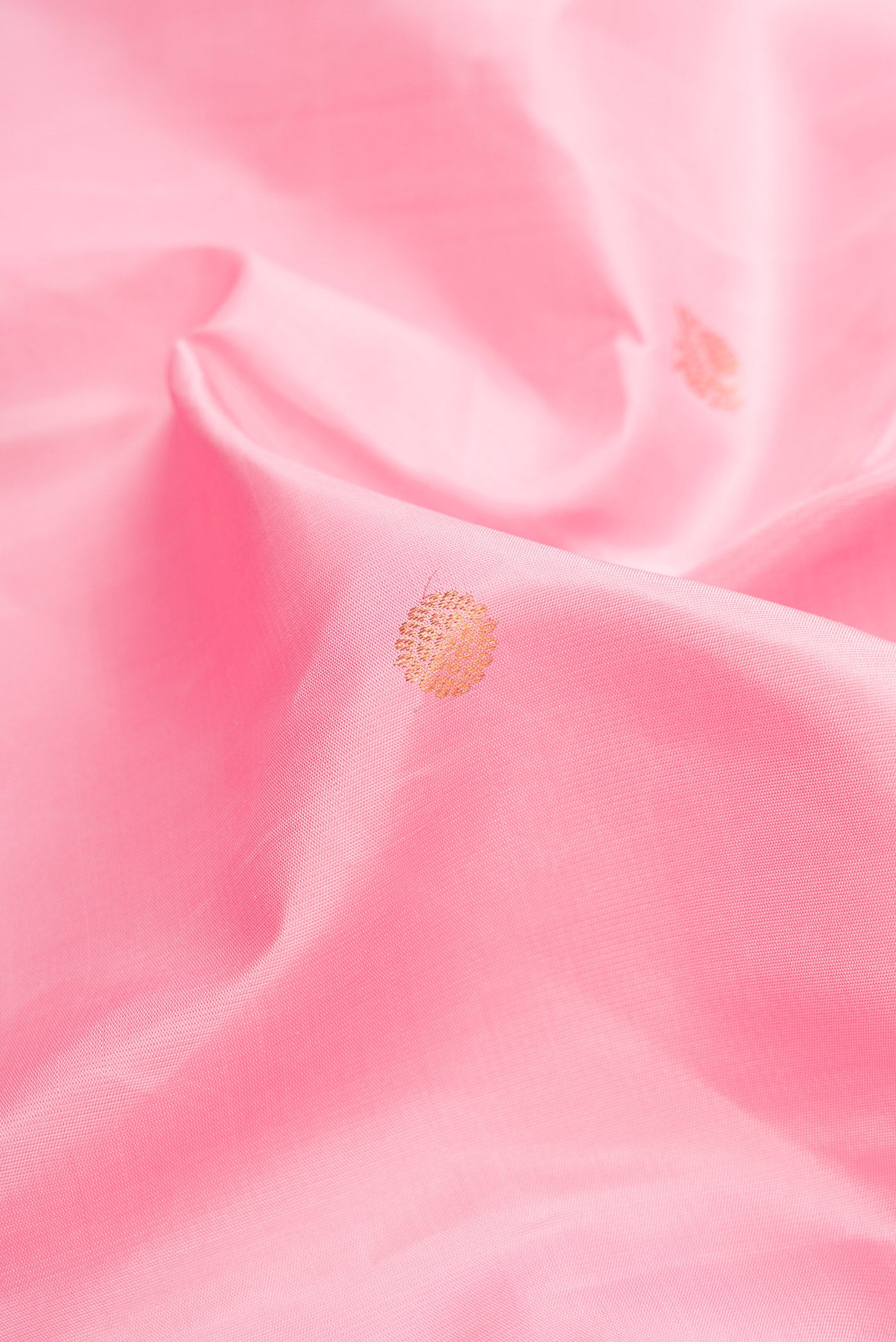 Close up of Pink Dual Tone Kanjivaram Silk Saree with Zari Butta on the body and Zari Border.  displaying folds