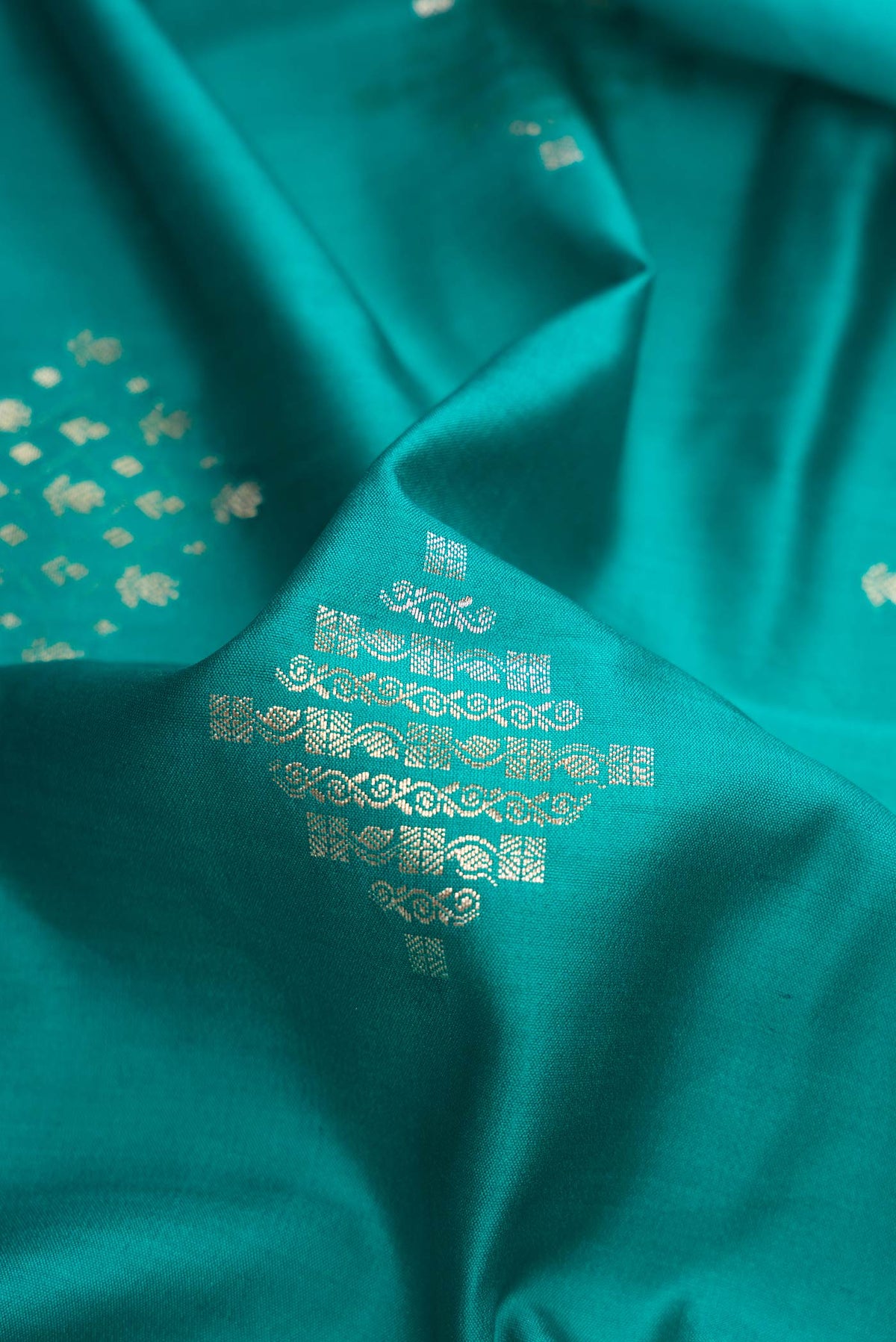 Close up of Sky Blue Dual Tone Tussar Silk Saree with Zari Brocade on the body and Zari Border.  displaying folds