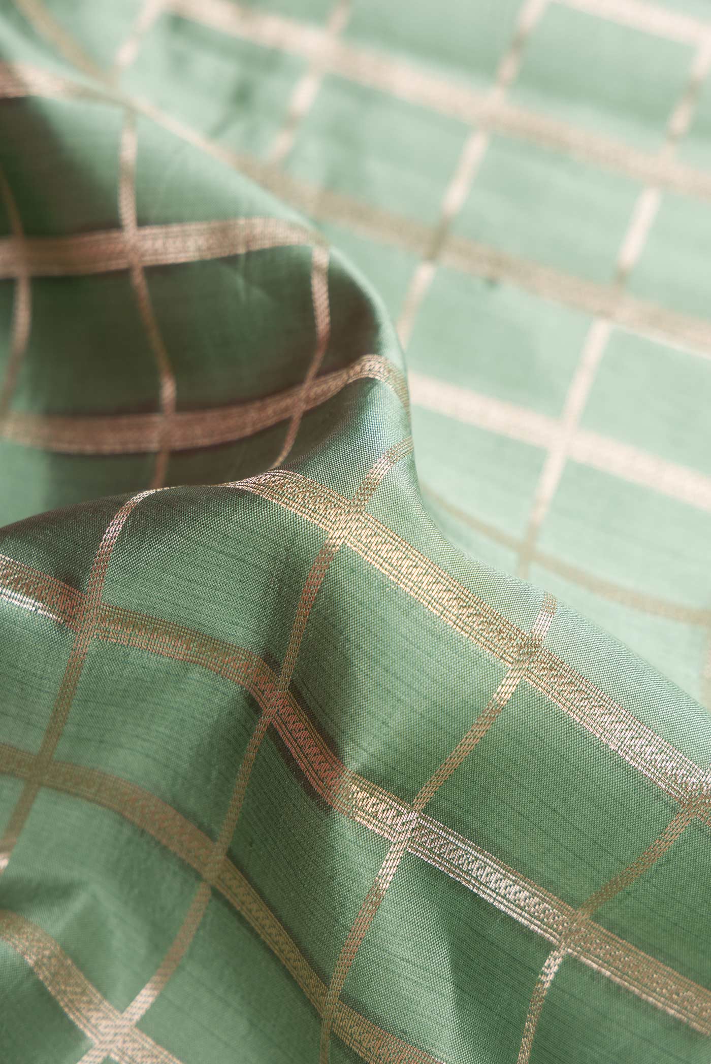Close up of Sky Blue Dual Tone Tussar Silk Saree with Zari Brocade on the body and Zari Border.  displaying folds