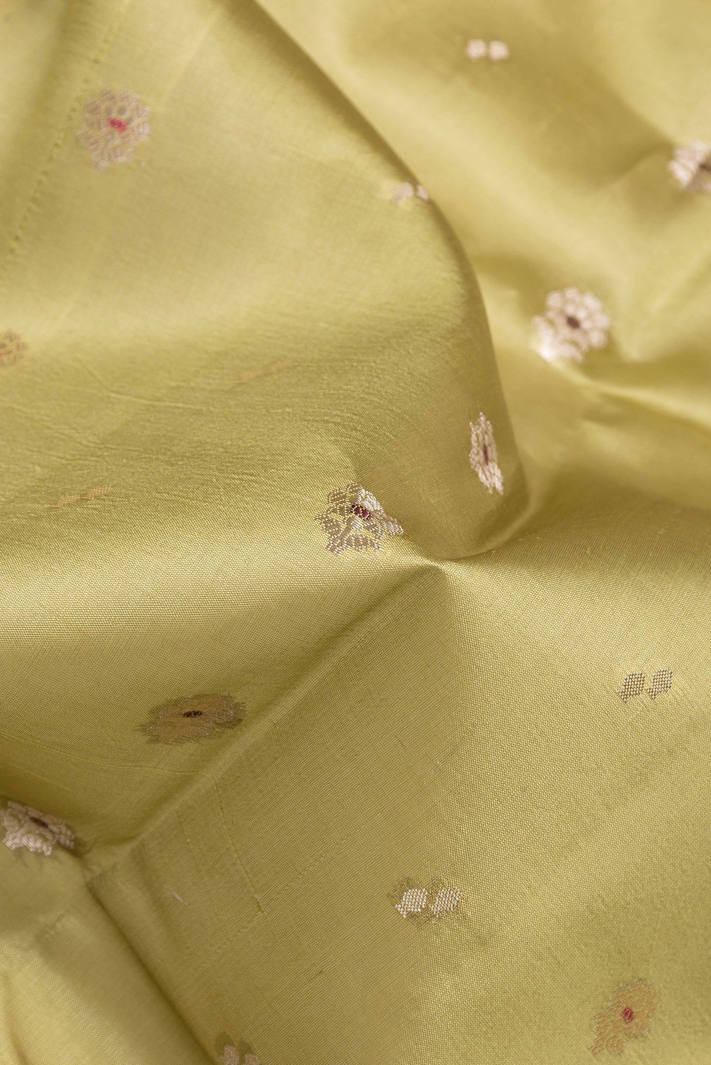 Close up of Mehandi Green Dual Tone Tussar Silk Saree with Zari Butta on the body and Fancy Border.  displaying folds