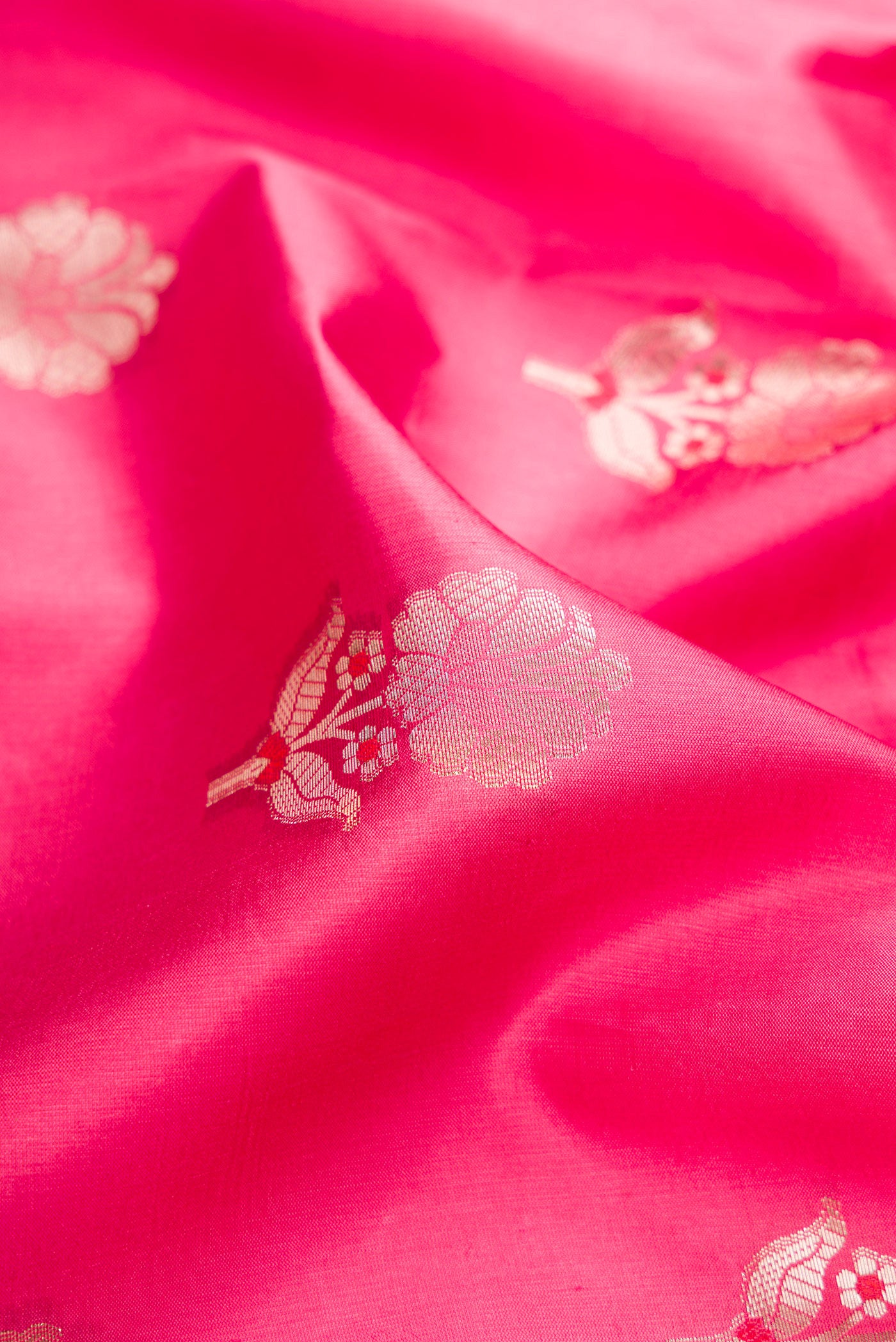 Close up of Pink Dual Tone Tussar Silk Saree with Zari Butta on the body and Zari Border.  displaying folds