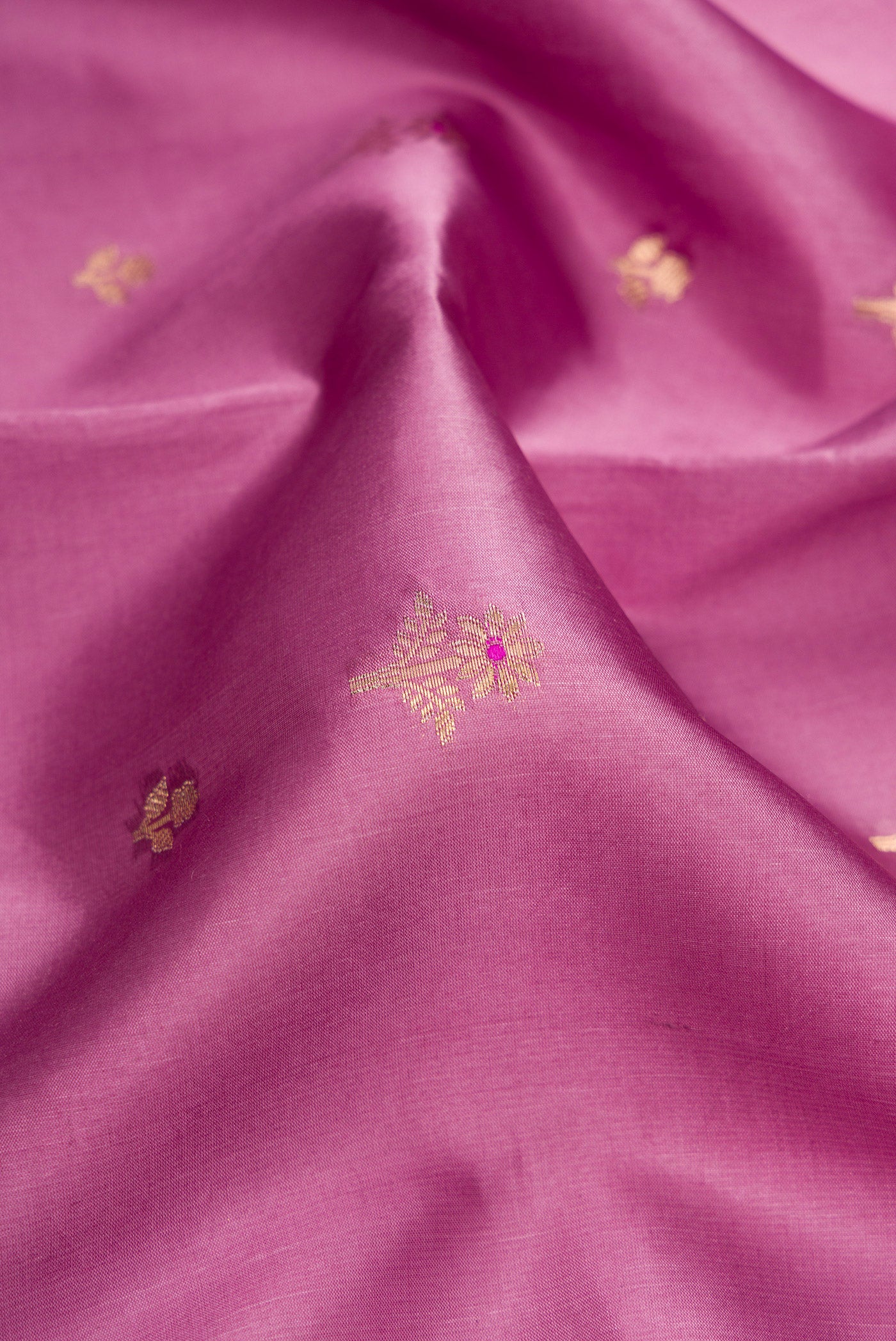 Close up of Purple Dual Tone Tussar Silk Saree with Zari Butta on the body and Fancy Border.  displaying folds