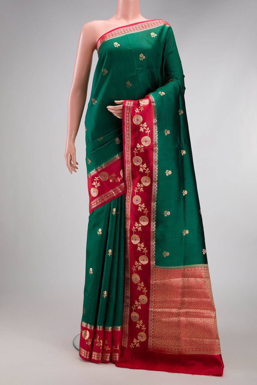 Bottle Green Dual Tone Tussar Silk Saree with Zari Butta on the body and Fancy Border.  displayed on a mannequin
