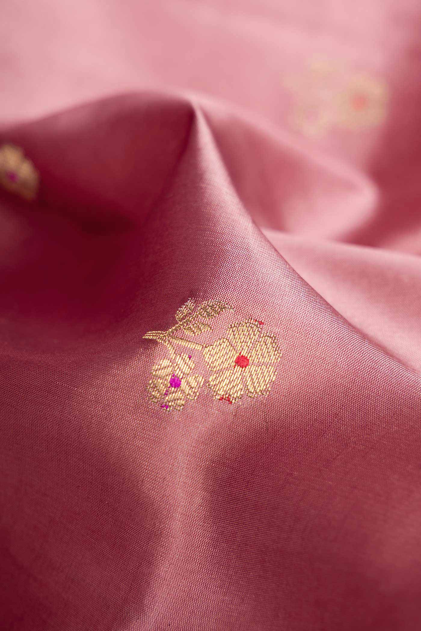 Close up of Rose Gold Dual Tone Tussar Silk Saree with Zari Butta on the body and Zari Border.  displaying folds