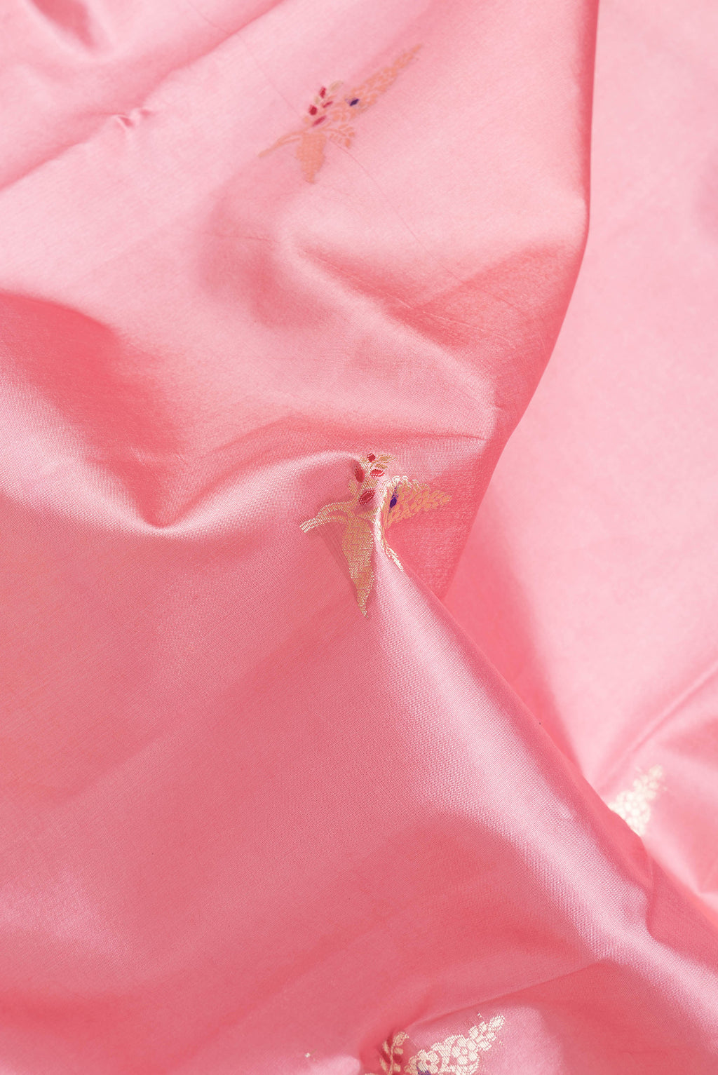 Close up of Pink Dual Tone Banarasi Raw Silk Saree with Zari Butta on the body and Zari Border.  displaying folds