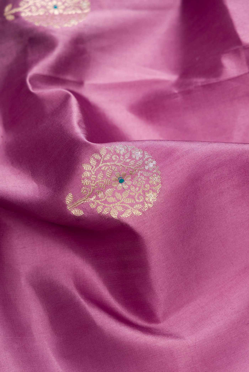 Close up of Lavender Dual Tone Tussar Silk Saree with Zari Butta on the body and Zari Border.  displaying folds