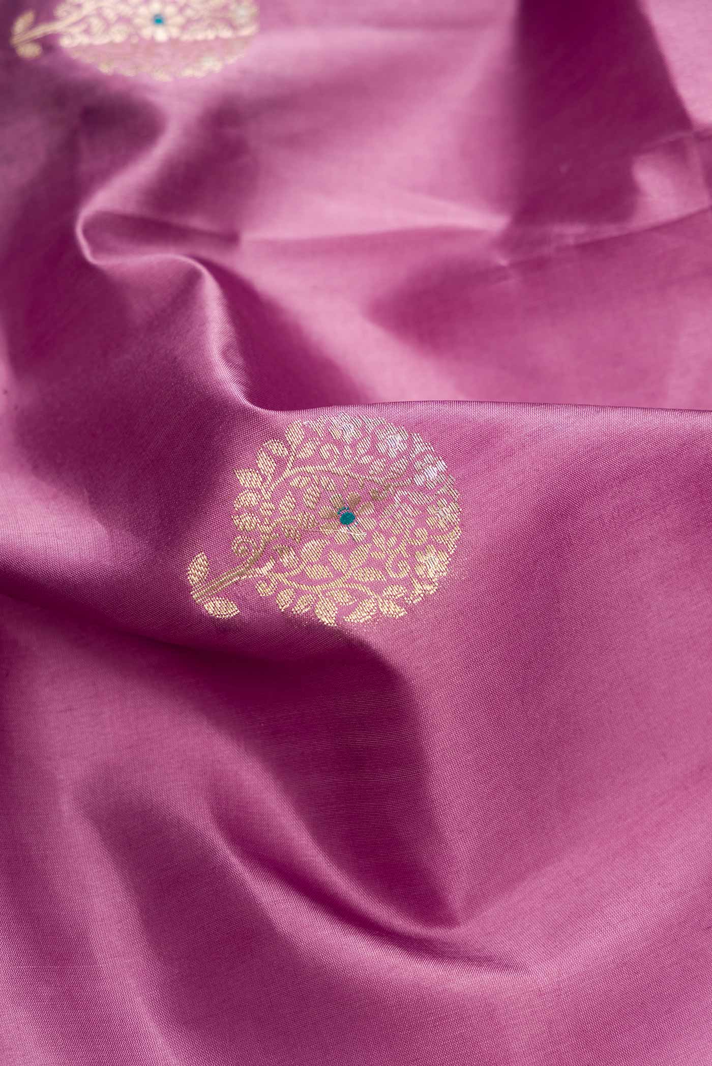 Close up of Lavender Dual Tone Tussar Silk Saree with Zari Butta on the body and Zari Border.  displaying folds