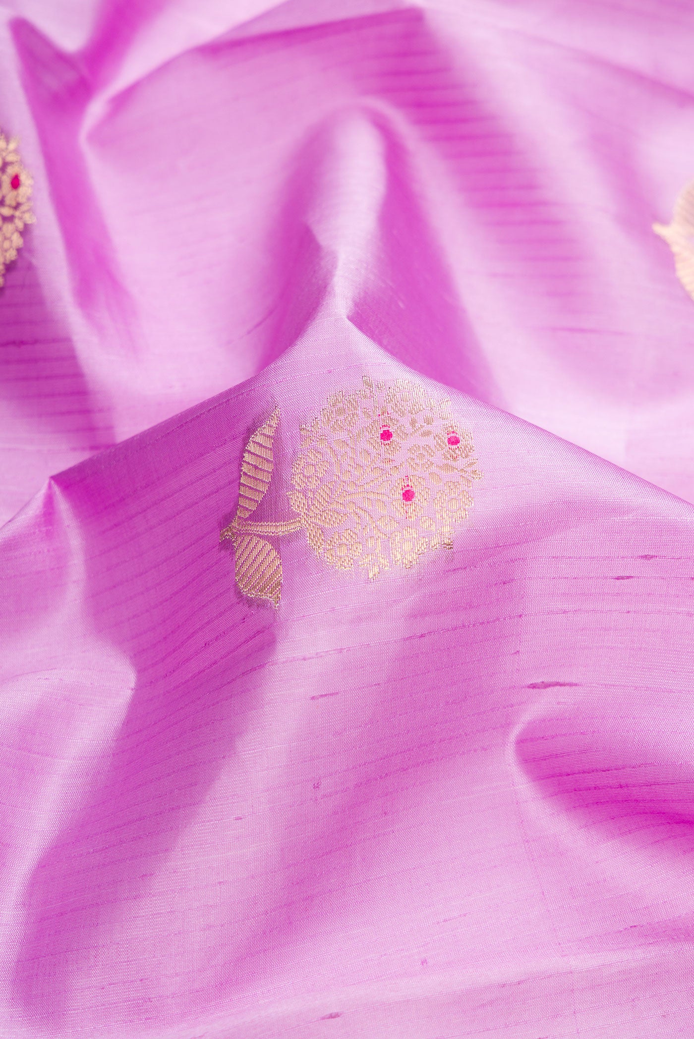 Close up of Lavender Dual Tone Tussar Silk Saree with Zari And Thread Butta on the body and Zari Border.  displaying folds