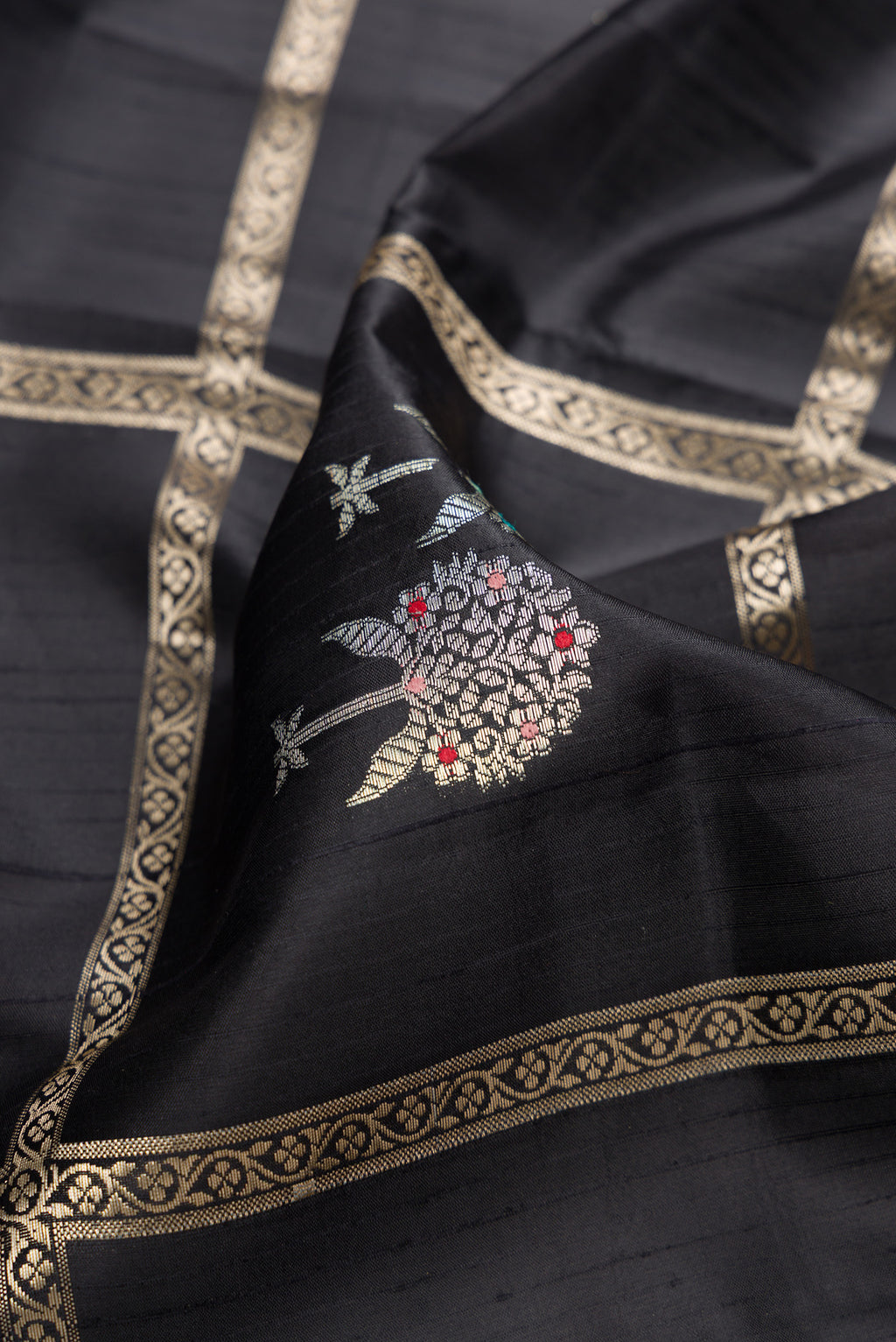 Close up of Black Dual Tone Tussar Silk Saree with Checked design on the body and Zari Border.  displaying folds