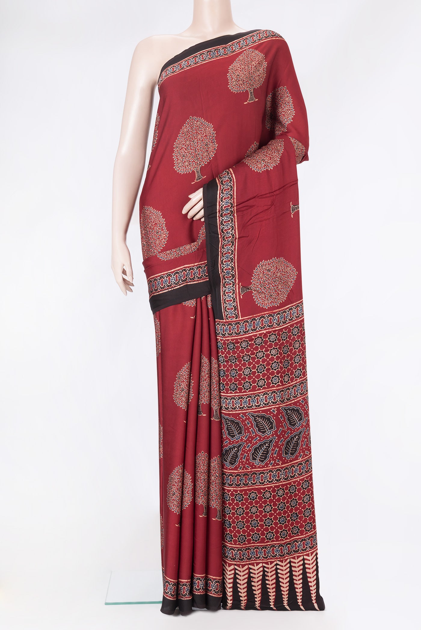Maroon Dual Tone Blended Crepe Saree with Ajrakh Print on the body and Fancy Border.  displayed on a mannequin