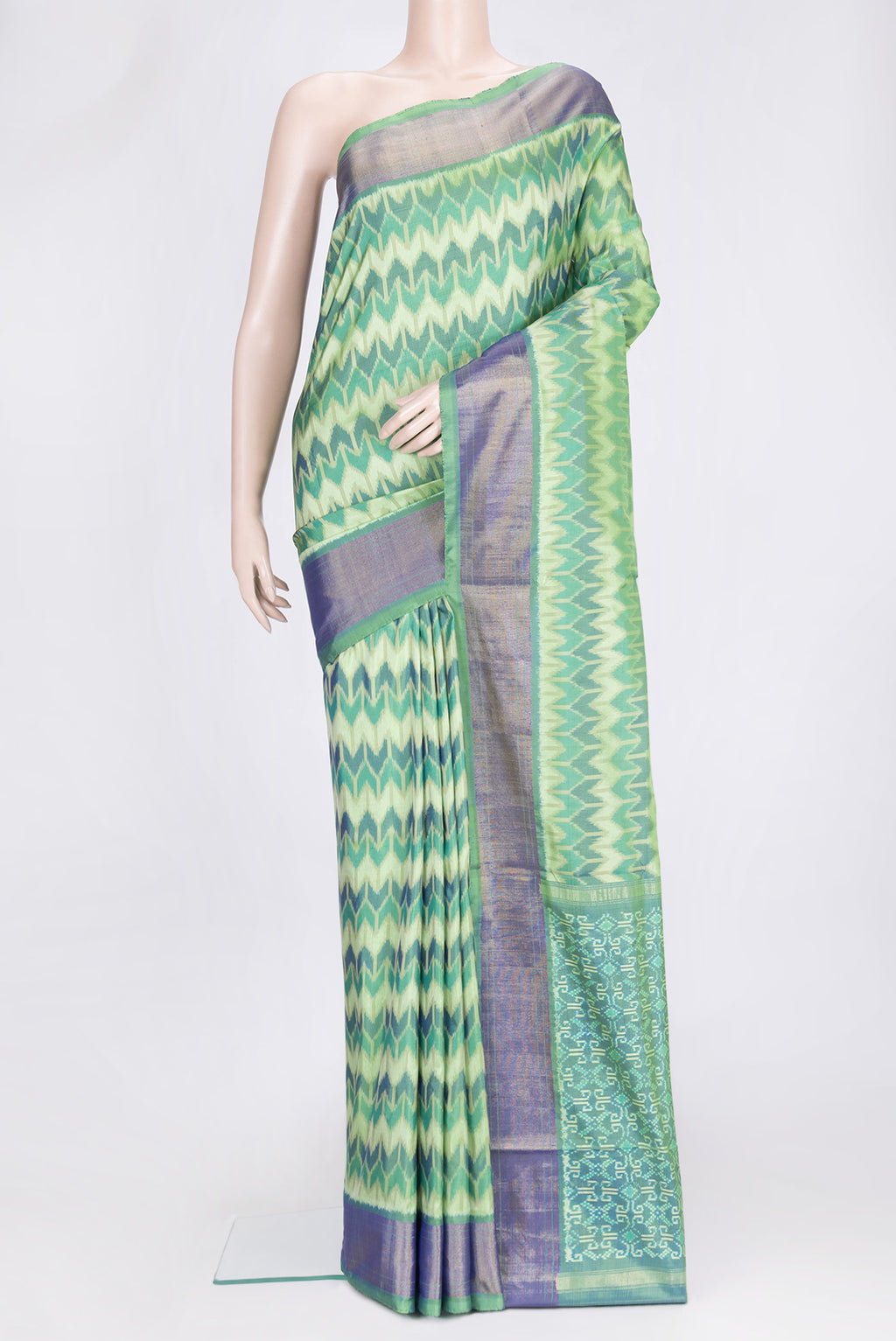 Green Dual Tone Double Ikat Saree with Ikat Print on the body and Zari Border.  displayed on a mannequin