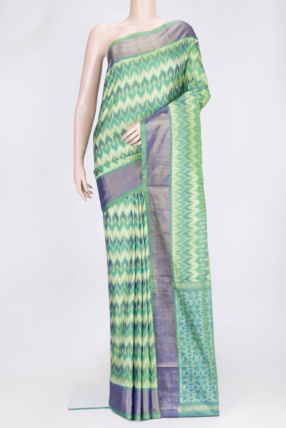 Green Dual Tone Double Ikat Saree with Ikat Print on the body and Zari Border.  displayed on a mannequin