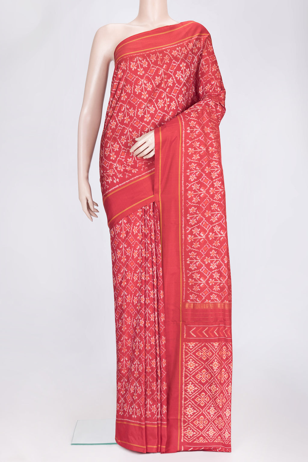 Red Dual Tone Double Ikat Saree with Ikat Print on the body and Plain Border.  displayed on a mannequin