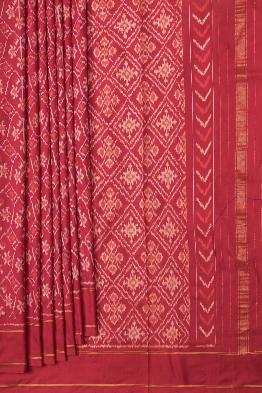 Pleats and pallu of Red Dual Tone Double Ikat Saree with Ikat Print on the body and Plain Border. 