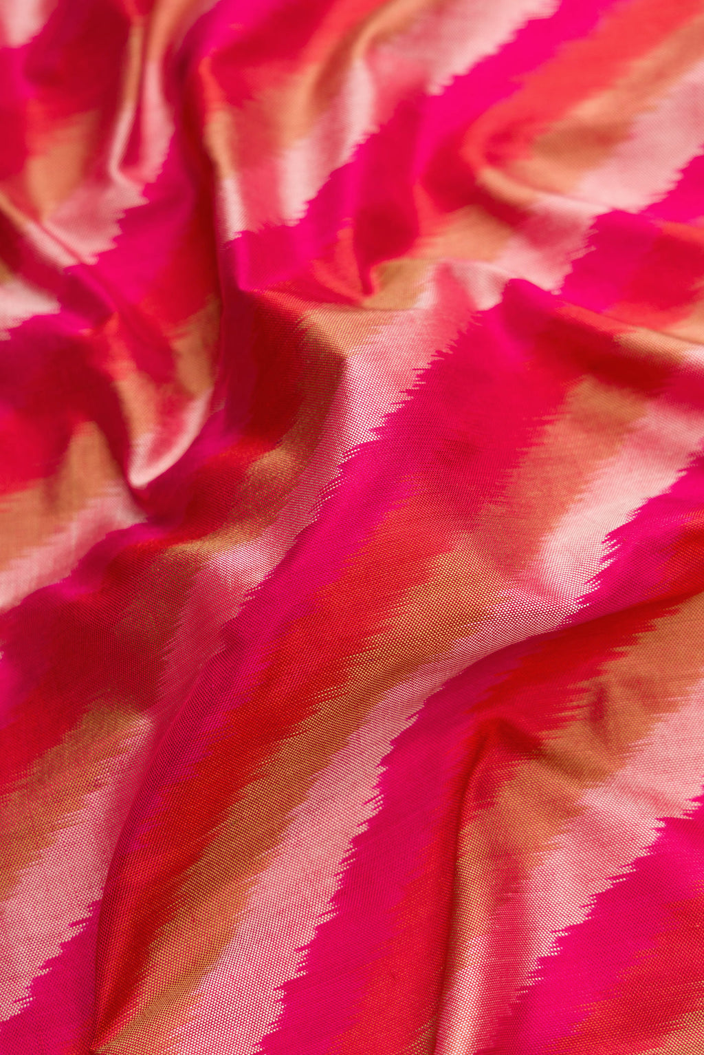 Close up of Pink Dual Tone Double Ikat Saree with Ikat Print on the body and Plain Border.  displaying folds