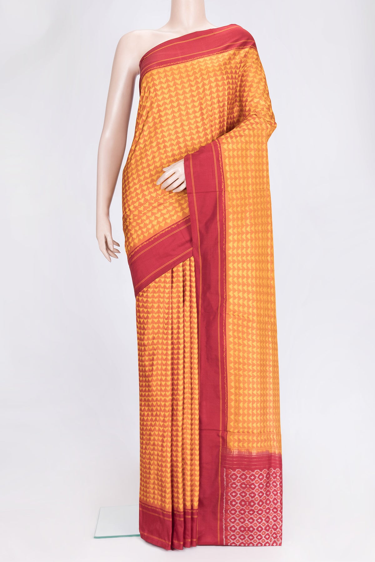 Mustard Dual Tone Double Ikat Saree with Ikat Print on the body and Plain Border.  displayed on a mannequin
