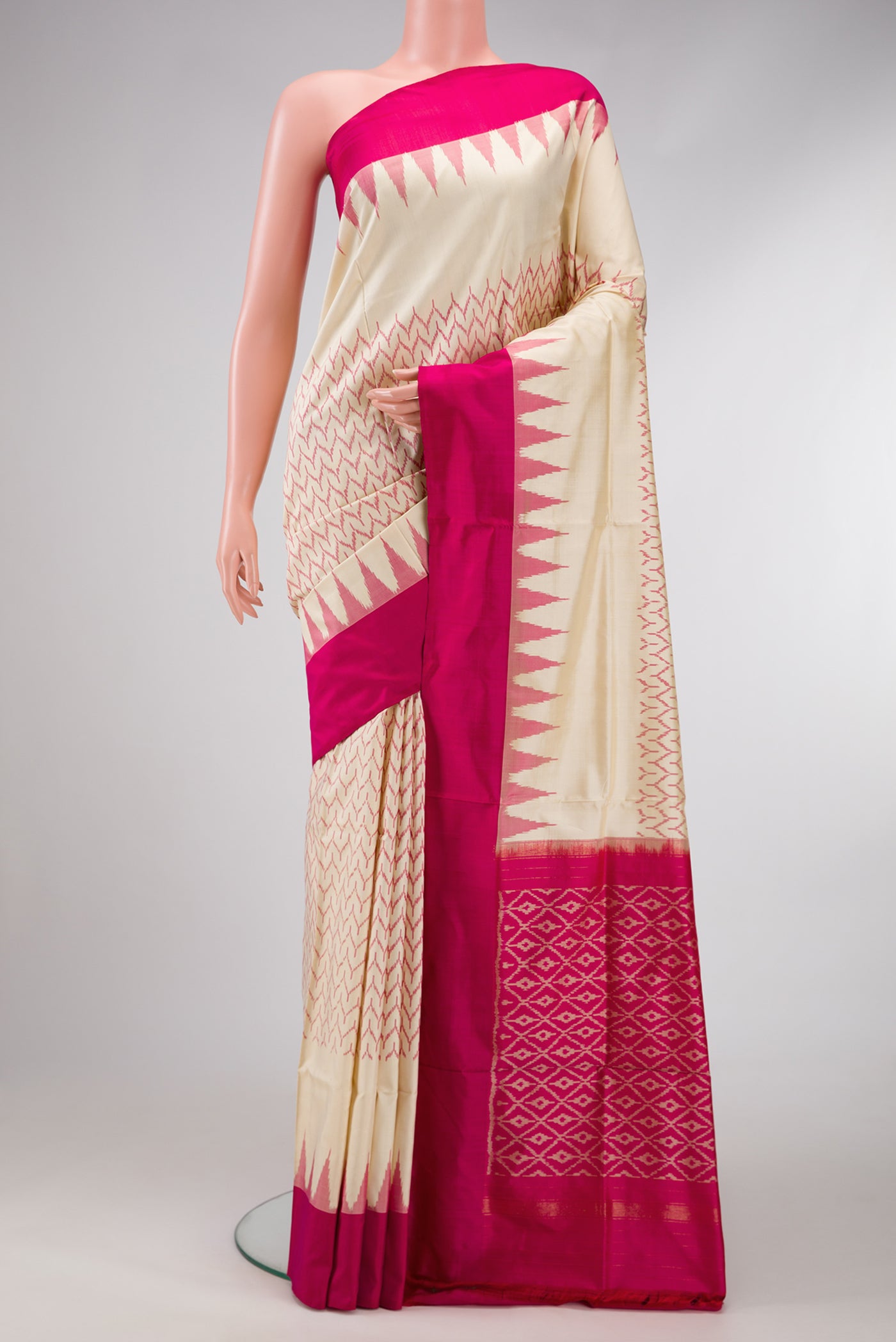 Off White Dual Tone Double Ikat Saree with Ikat Print on the body and Temple Border.  displayed on a mannequin