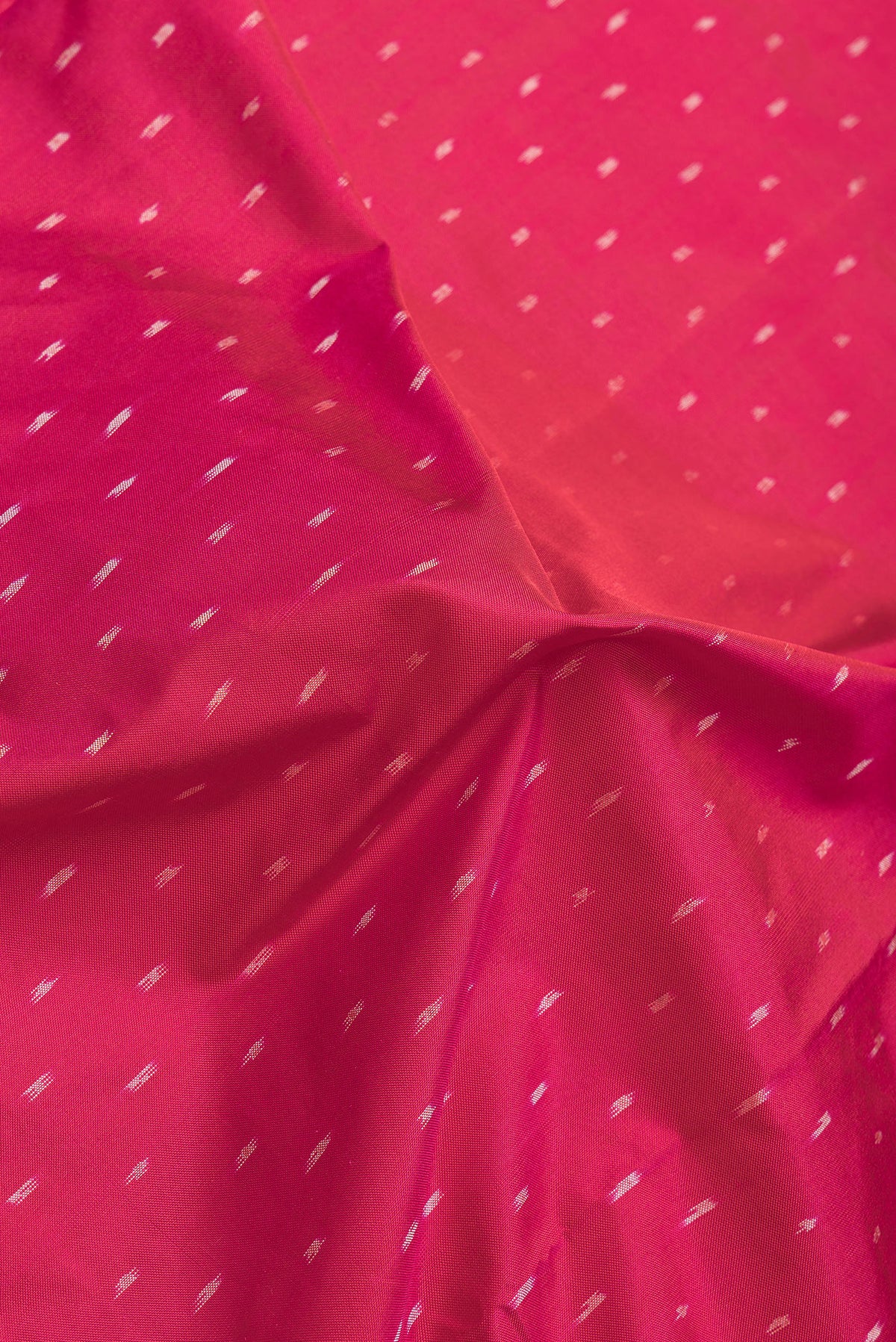 Close up of Maroon Dual Tone Double Ikat Saree with Ikat Print on the body and Plain Border.  displaying folds