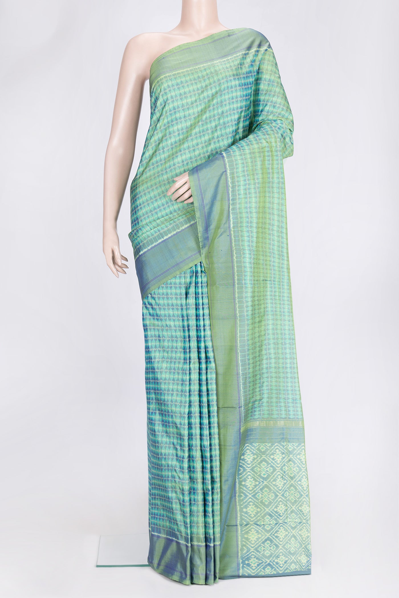 Green Dual Tone Double Ikat Saree with Ikat Print on the body and Plain Border.  displayed on a mannequin