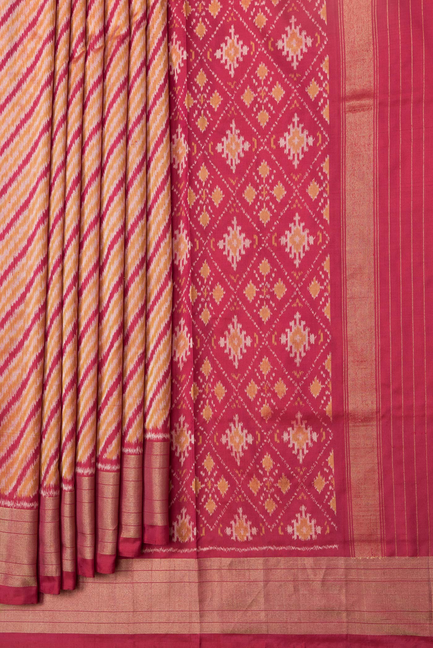 Pleats and pallu of Maroon Dual Tone Double Ikat Saree with Ikat Print on the body and Plain Border. 