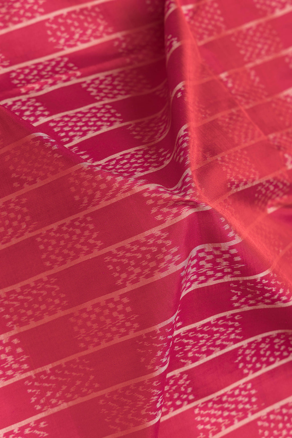 Close up of Pink Dual Tone Double Ikat Saree with Ikat Print on the body and Plain Border.  displaying folds