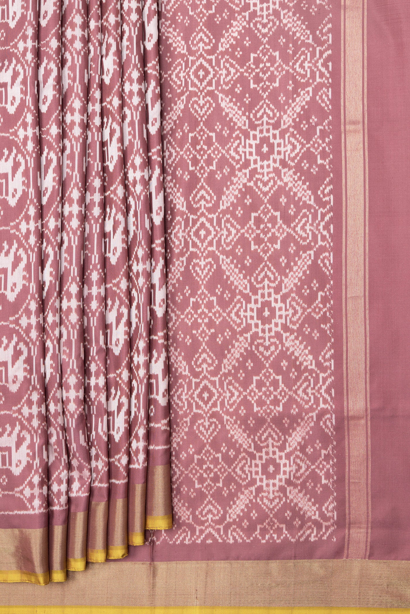 Pleats and pallu of Brown Dual Tone Double Ikat Saree with Ikat Print on the body and Zari Border. 