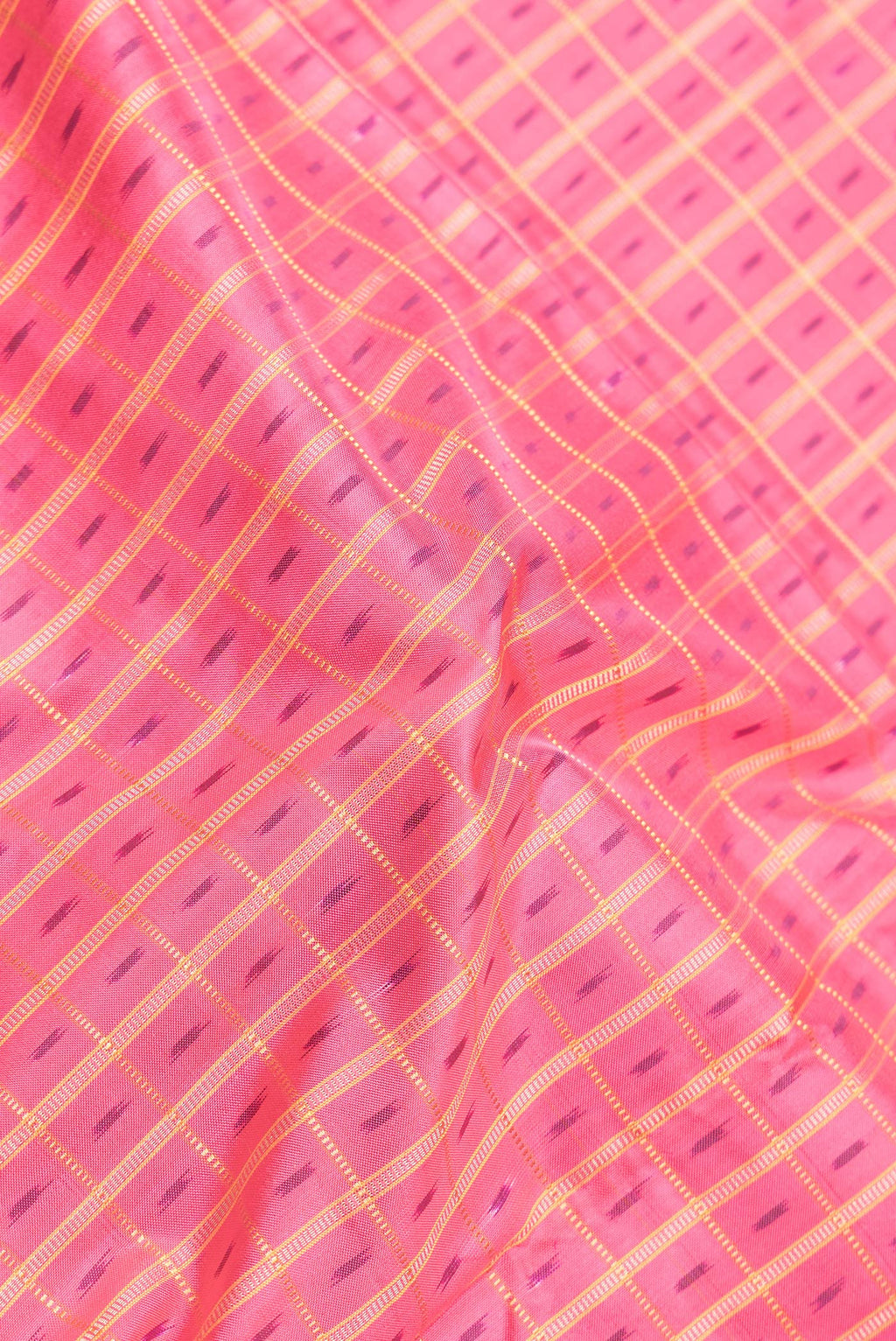 Close up of Pink Dual Tone Double Ikat Saree with Ikat Print on the body and Zari Border.  displaying folds