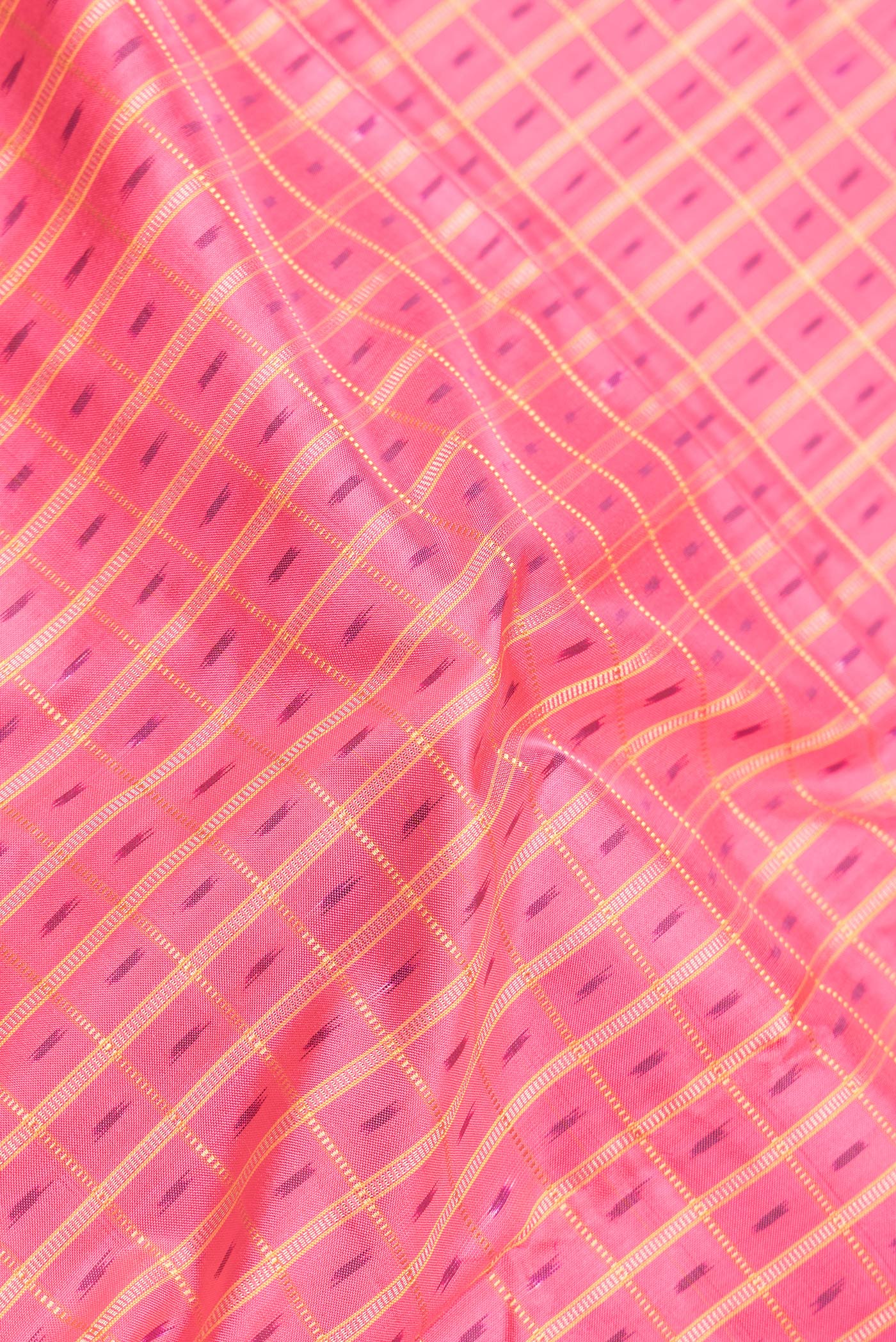 Close up of Pink Dual Tone Double Ikat Saree with Ikat Print on the body and Zari Border.  displaying folds