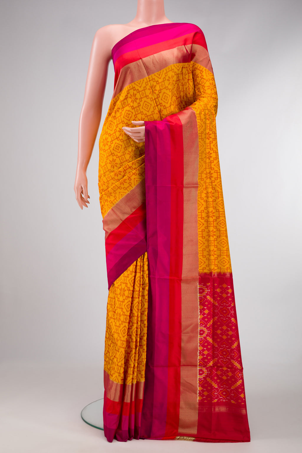 Mustard Dual Tone Double Ikat Saree with Ikat Print on the body and Zari Border.  displayed on a mannequin