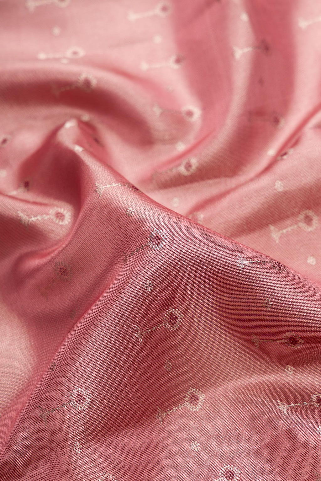 Close up of Pink Dual Tone Kanjivaram Tissue Silk Saree with Zari Brocade on the body and Zari Border.  displaying folds