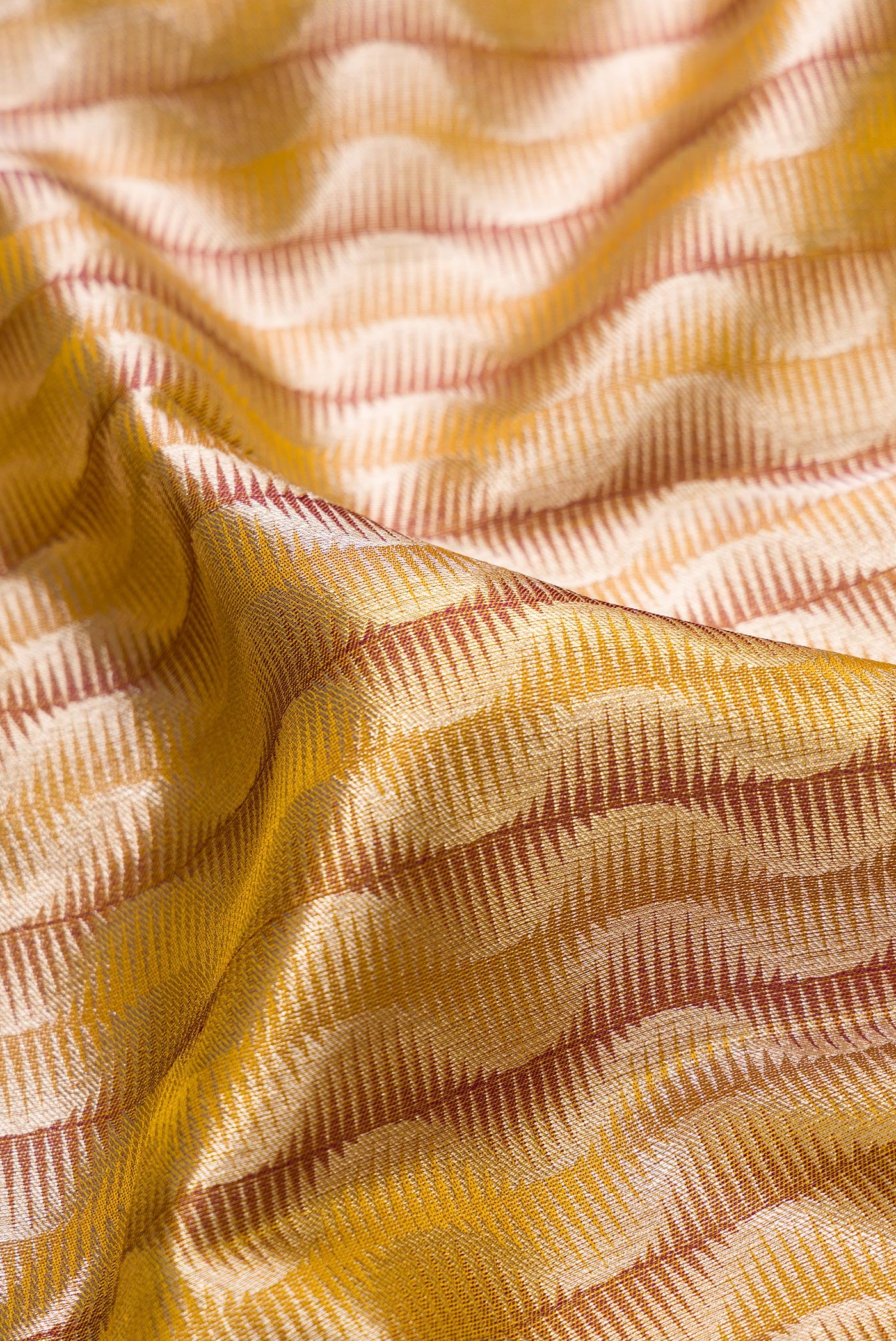 Close up of Mehandi Green Dual Tone Kanjivaram Tissue Silk Saree with Zari Brocade on the body and Zari Border.  displaying folds
