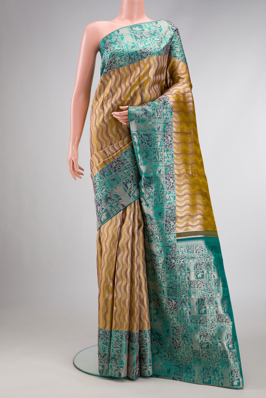 Mehandi Green Dual Tone Kanjivaram Tissue Silk Saree with Zari Brocade on the body and Zari Border.  displayed on a mannequin