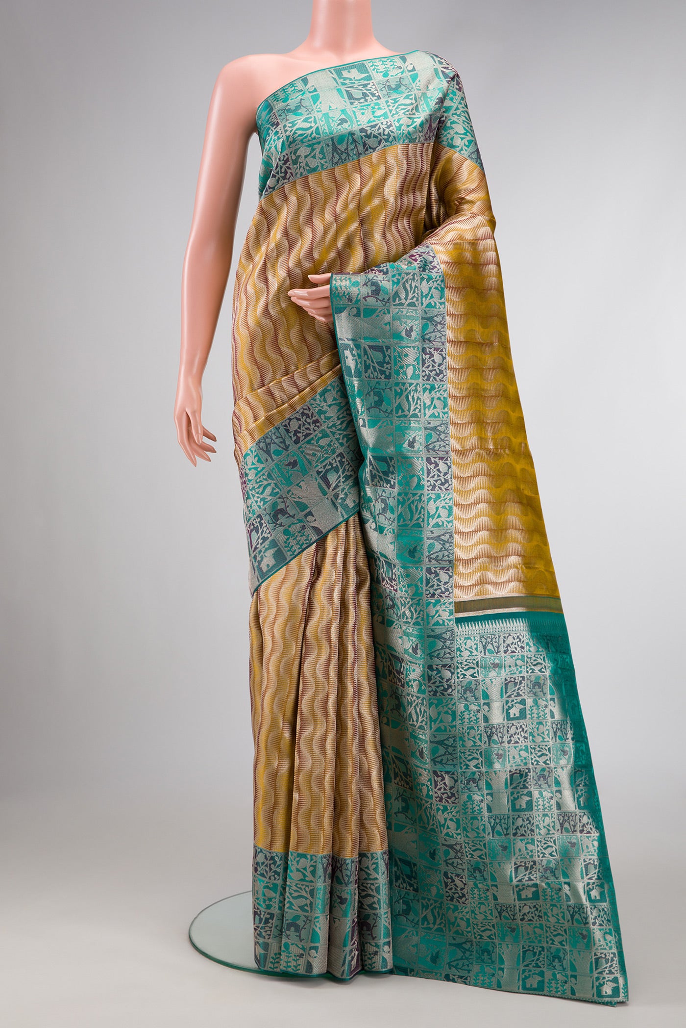 Mehandi Green Dual Tone Kanjivaram Tissue Silk Saree with Zari Brocade on the body and Zari Border.  displayed on a mannequin