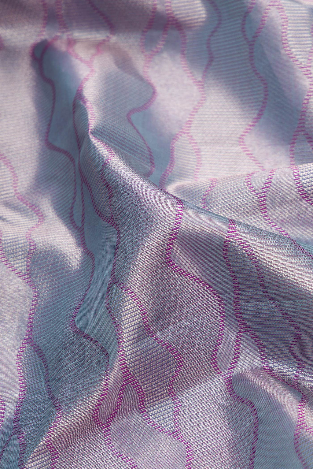 Close up of Grey Dual Tone Kanjivaram Tissue Silk Saree with Zari Brocade on the body and Fancy Border.  displaying folds