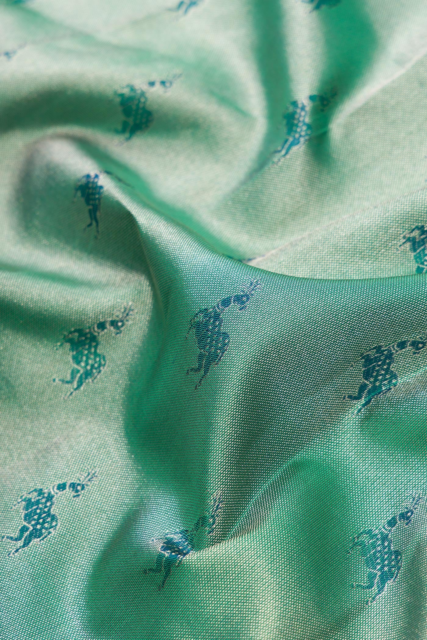 Close up of Green Dual Tone Kanjivaram Tissue Silk Saree with Zari Brocade on the body and Fancy Border.  displaying folds