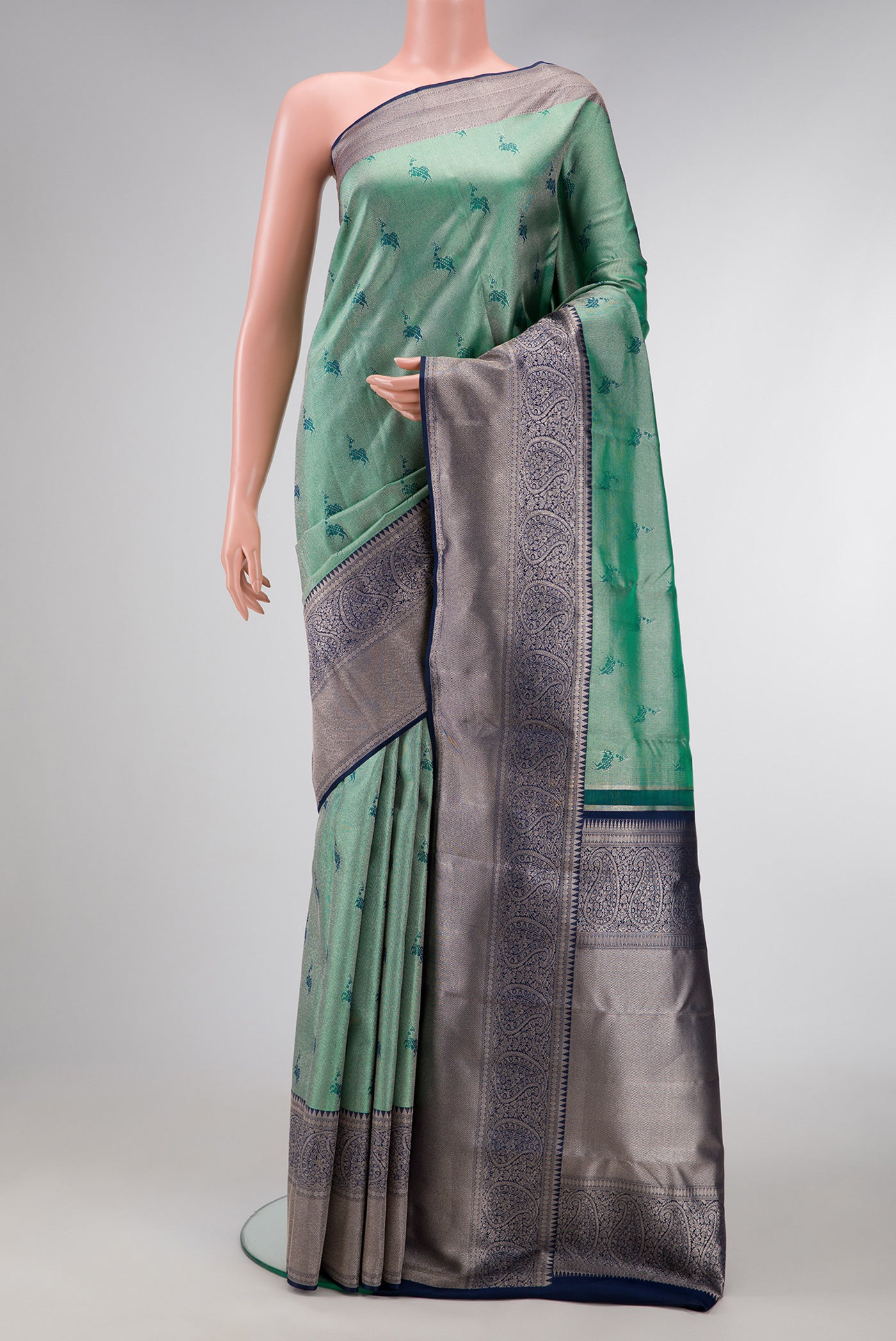 Green Dual Tone Kanjivaram Tissue Silk Saree with Zari Brocade on the body and Fancy Border.  displayed on a mannequin