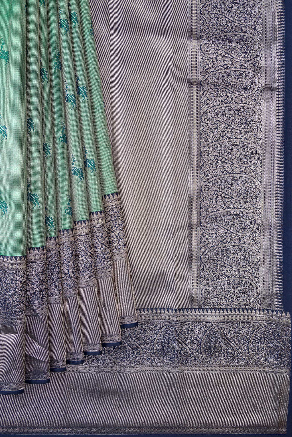Pleats and pallu of Green Dual Tone Kanjivaram Tissue Silk Saree with Zari Brocade on the body and Fancy Border. 